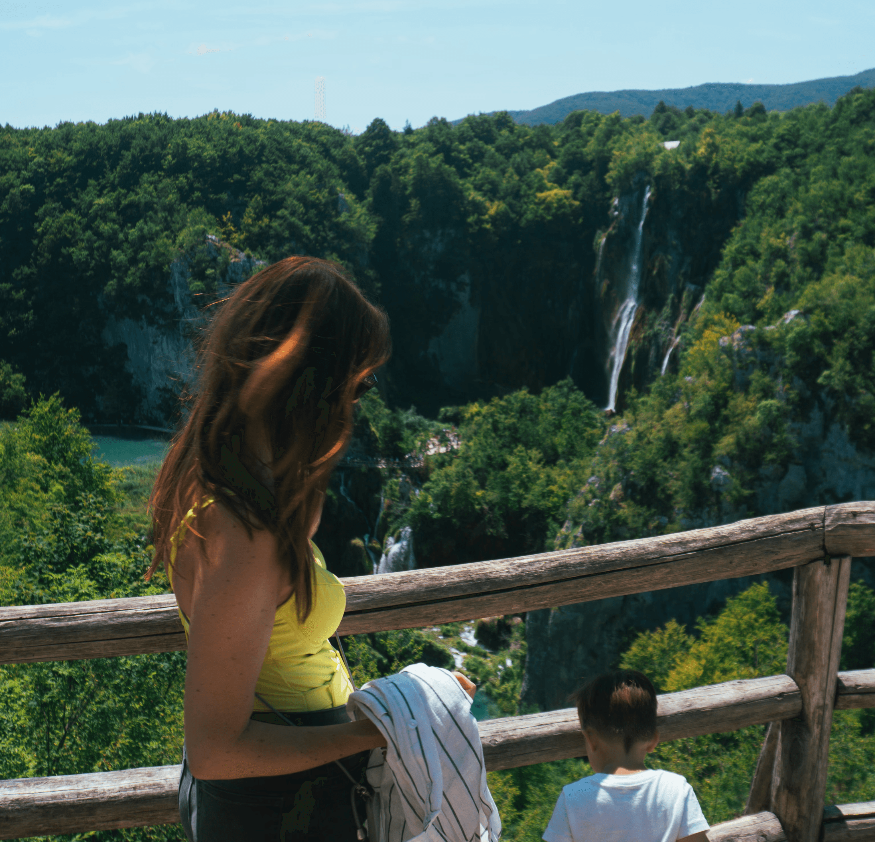Portrait of a laughing person with curly hair wearing a white shirt