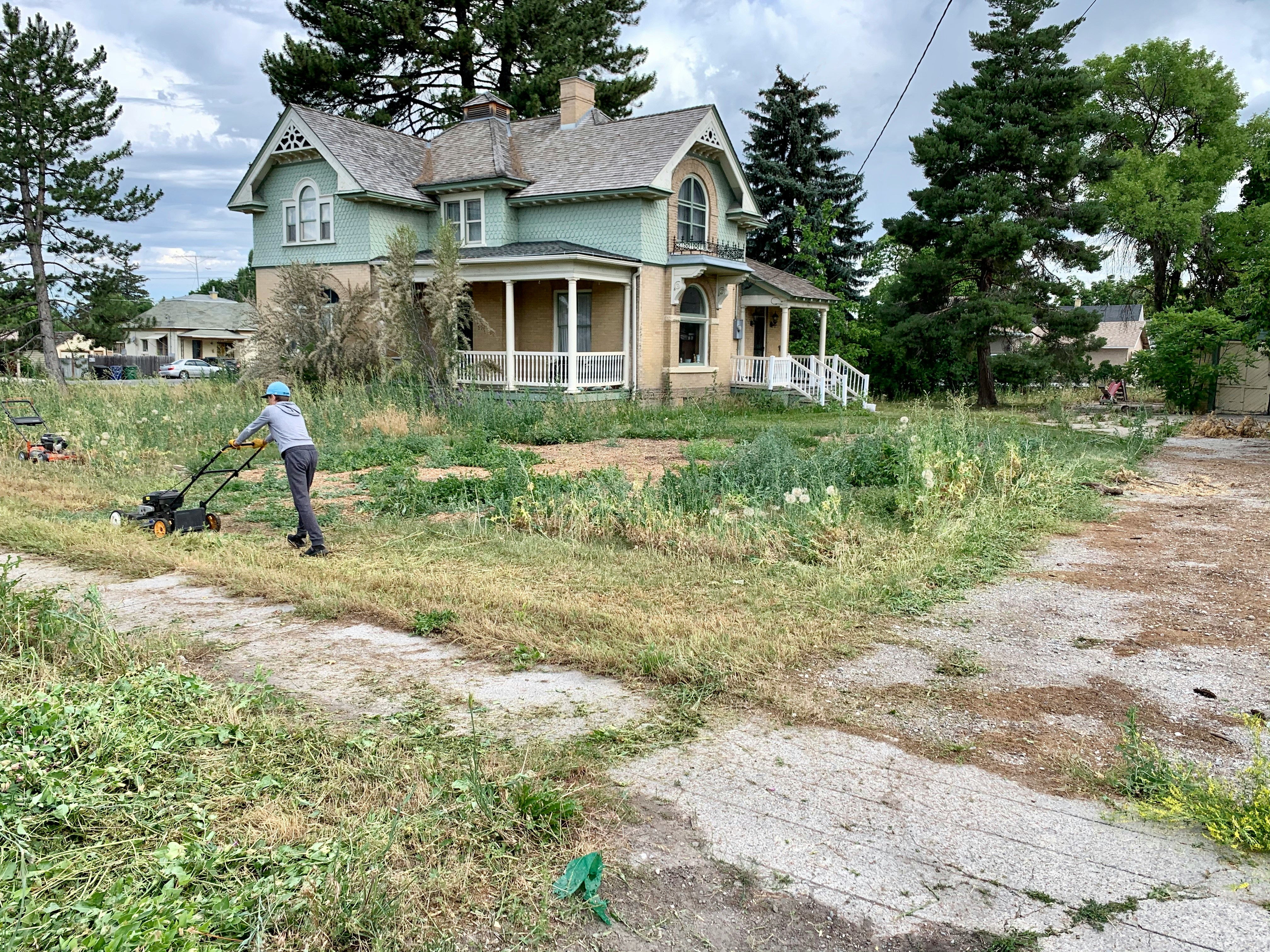 A tired front yard with a cracked path before work