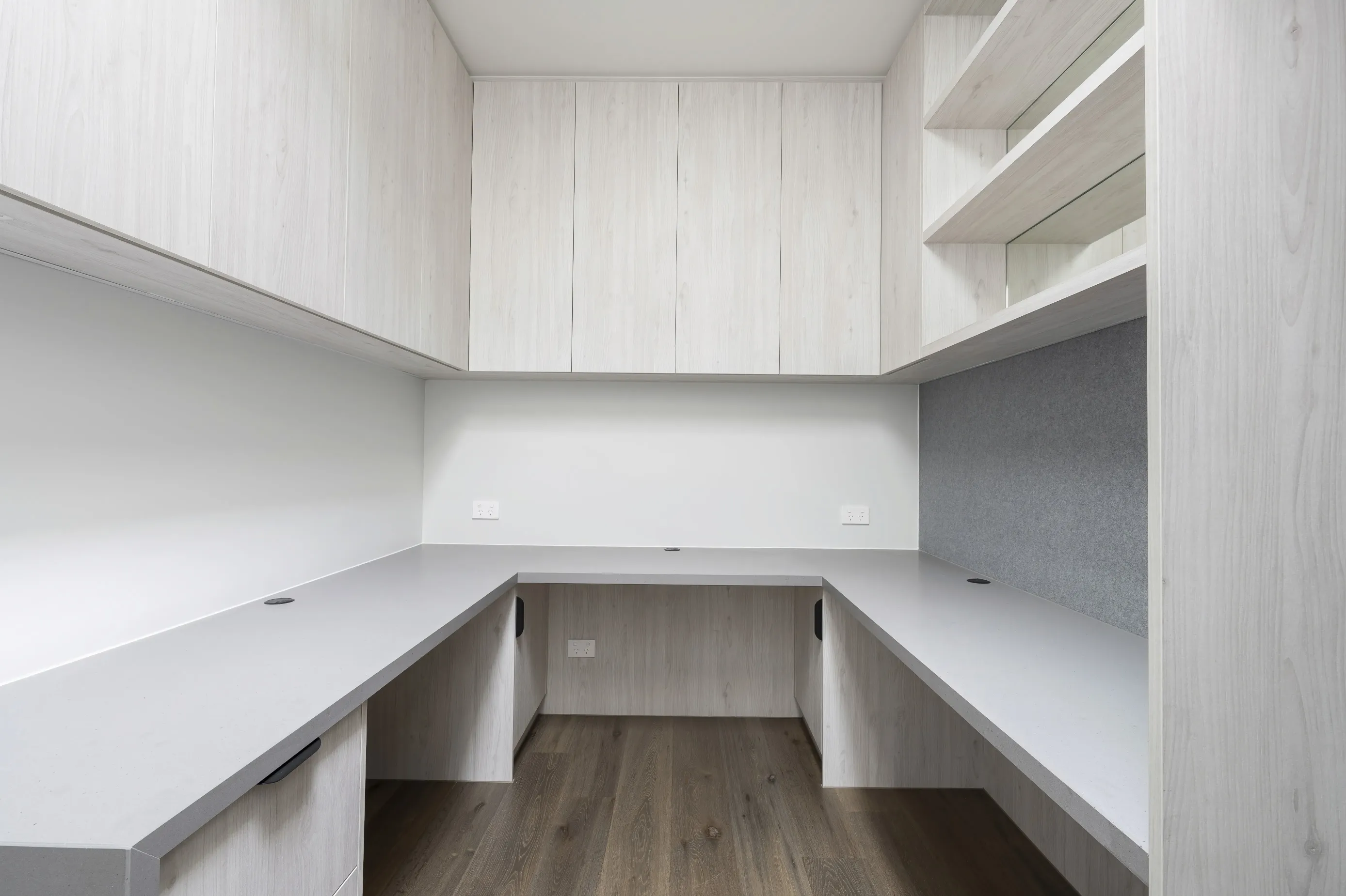 Built-in study nook in the Bundoora Residence with whitewashed oak joinery and a U-shaped desk