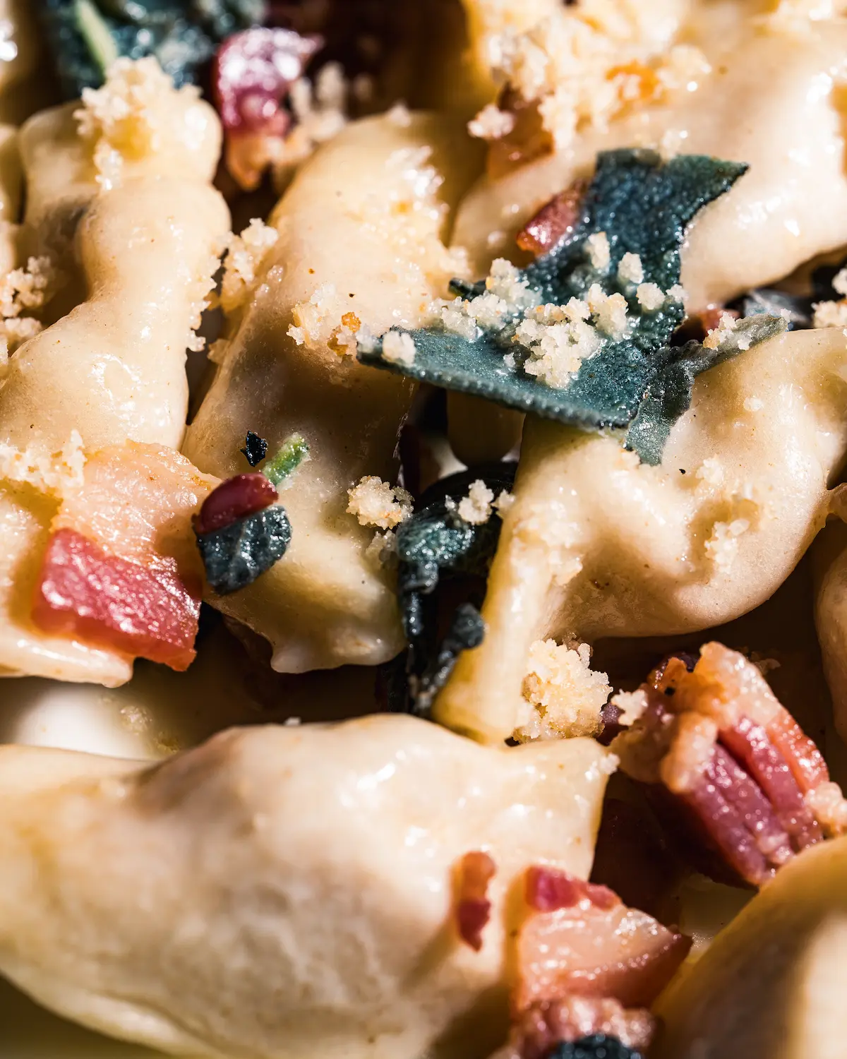 A rustic outdoor dining table set with wine glasses, cutlery, bread, and olives sits amidst lush vineyard rows, with a historic Tuscan villa in the background under a serene sky, capturing the essence of a picturesque Italian countryside landscape.