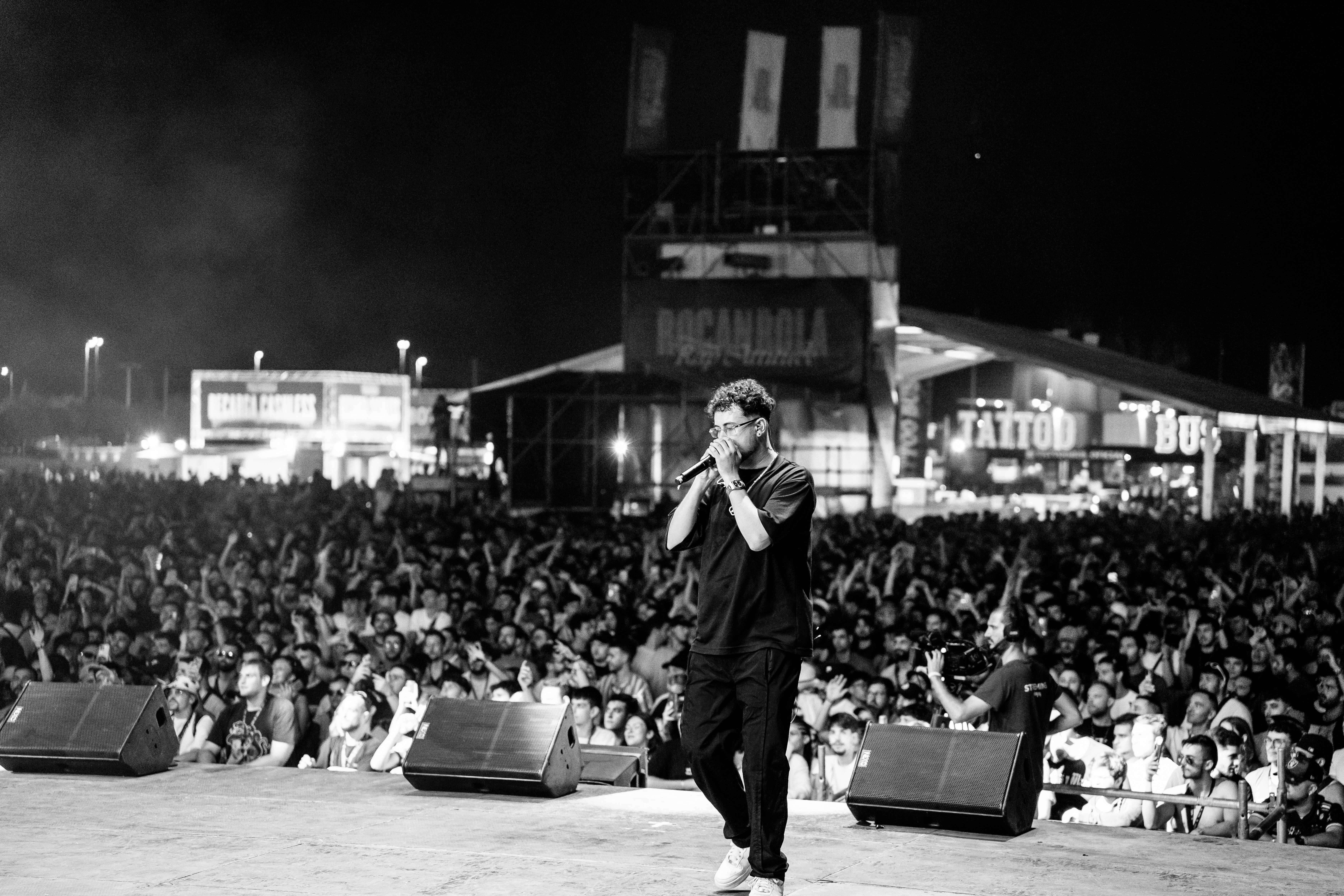 Two men wearing yellow and black face masks, standing side by side, with neutral expressions on their faces.