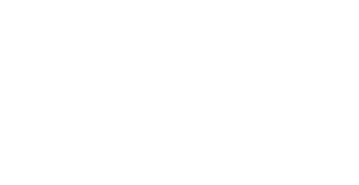 A girl with her hand near her face standing in front of yellow and white neon signs