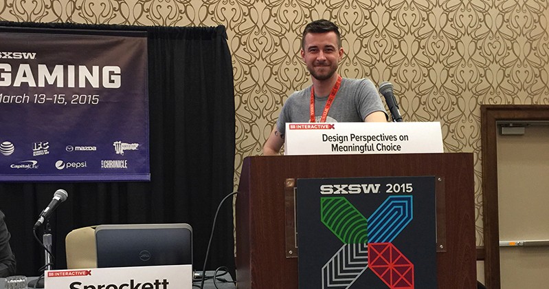 A photo of a man giving a lecture at a stand regarding SXSW Gaming.