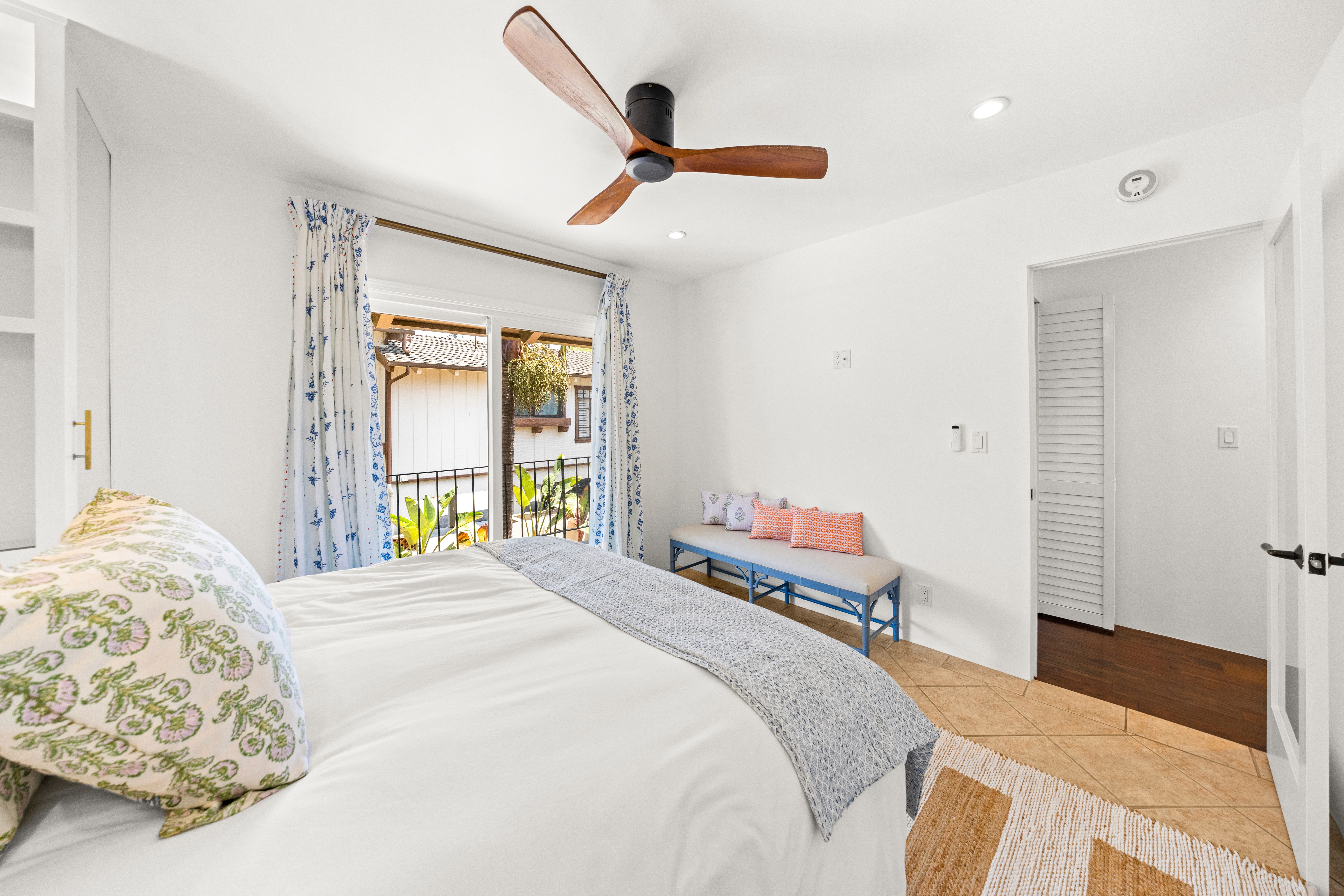 evening mood lighting, with the balcony doors open, glowing bedside lamps, sunset light streaming in.