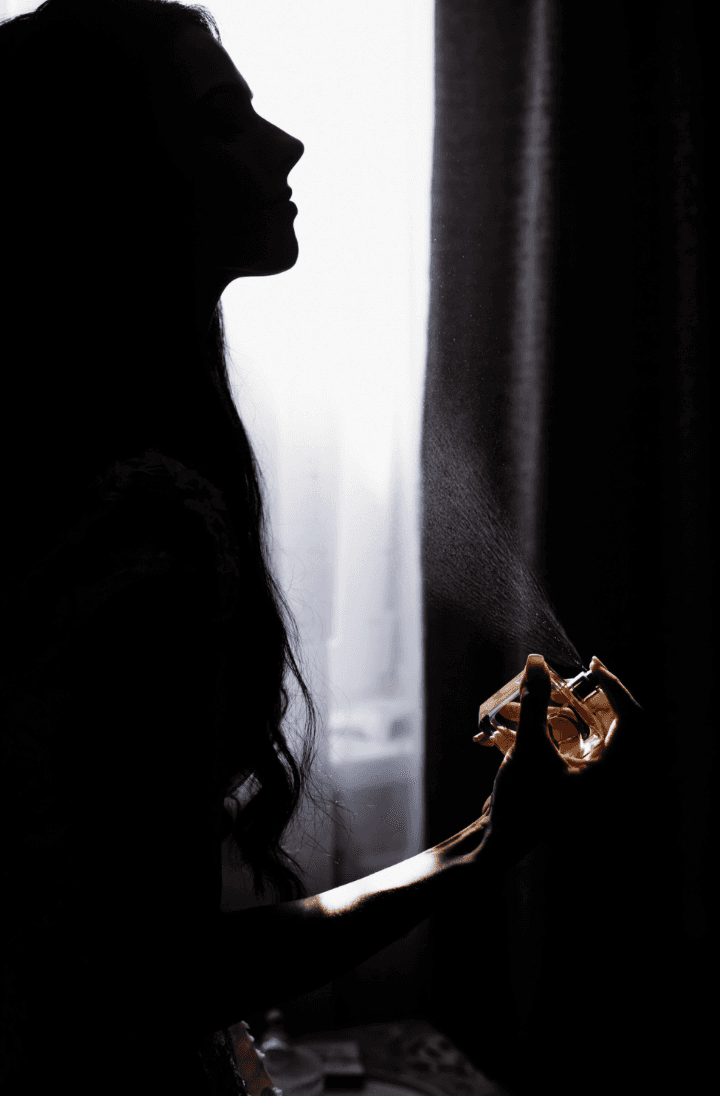 woman spraying perfume fragrance