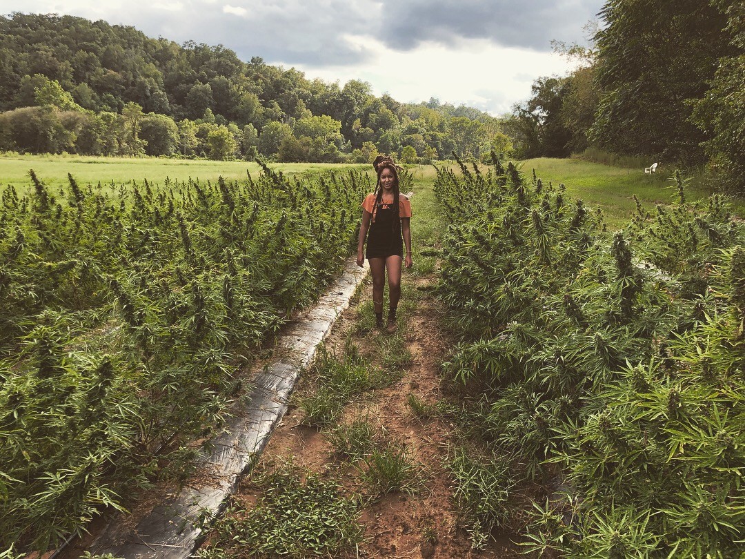 A woman holding her brand product and posing for a photo.
