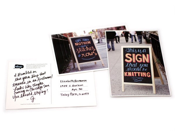 The image shows three photographs displayed on a white surface. The left photograph is a white postcard with a handwritten note in black ink that reads, “I stumbled on this yarn shop that travels in an Airstream! Looks like they’re coming to Chicago soon. You should stop by!” The right photograph shows two chalkboard-style signs leaning against a dark metal fence. The sign on the left reads “LIVE ANYTHING BUT STITCHES ROWS” in chalk. The sign on the right reads “This is a SIGN that you should be KNITTING” in chalk. The signs are leaning against the fence, and blurred figures of people can be seen walking in the background. The third photograph is partially visible behind the other two but is not fully legible.