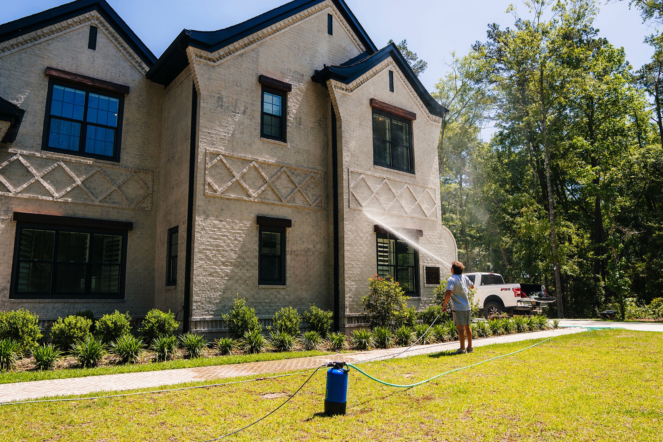 Full house shot of person powerwashing