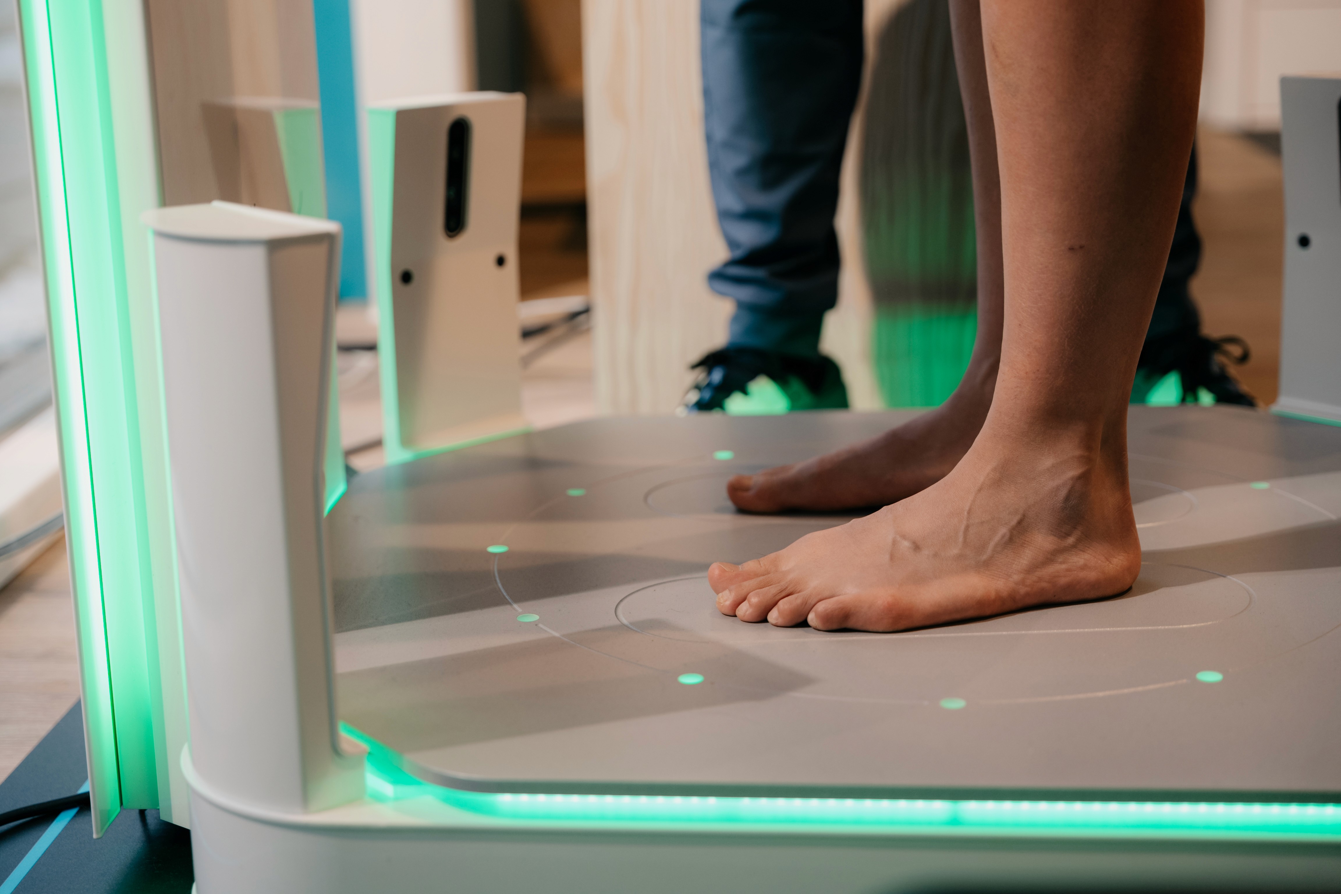A large group photo of diverse team members gathered in an industrial-style space with arched ceiling.