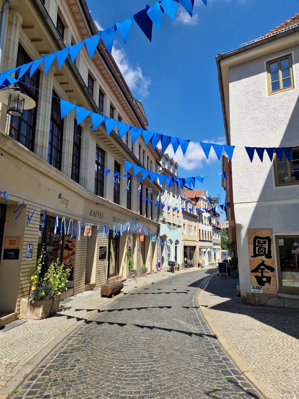 Windischengasse in Weimar with blue bunting above the cobbles