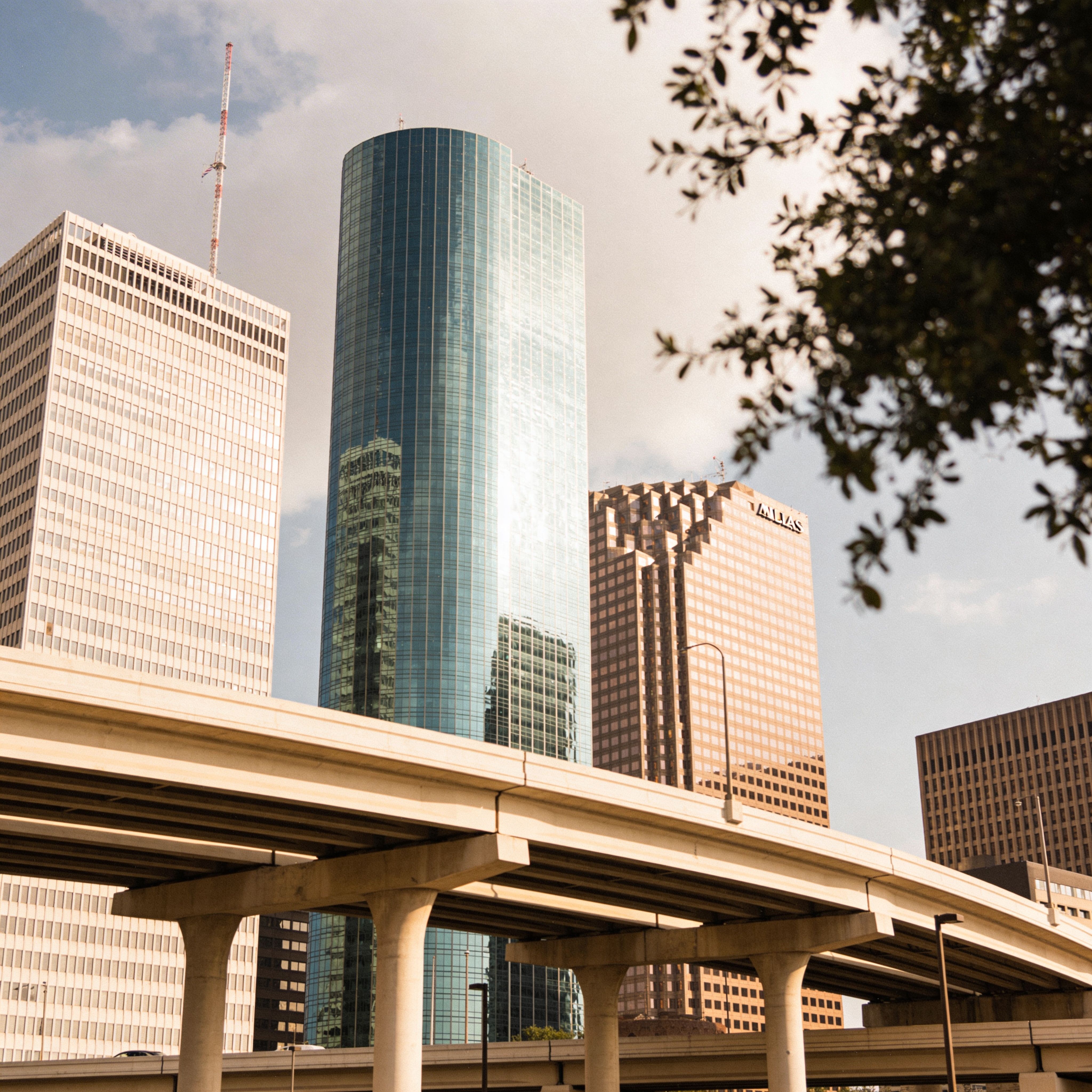 Modern city skyline with glass office towers and elevated highway in Dallas