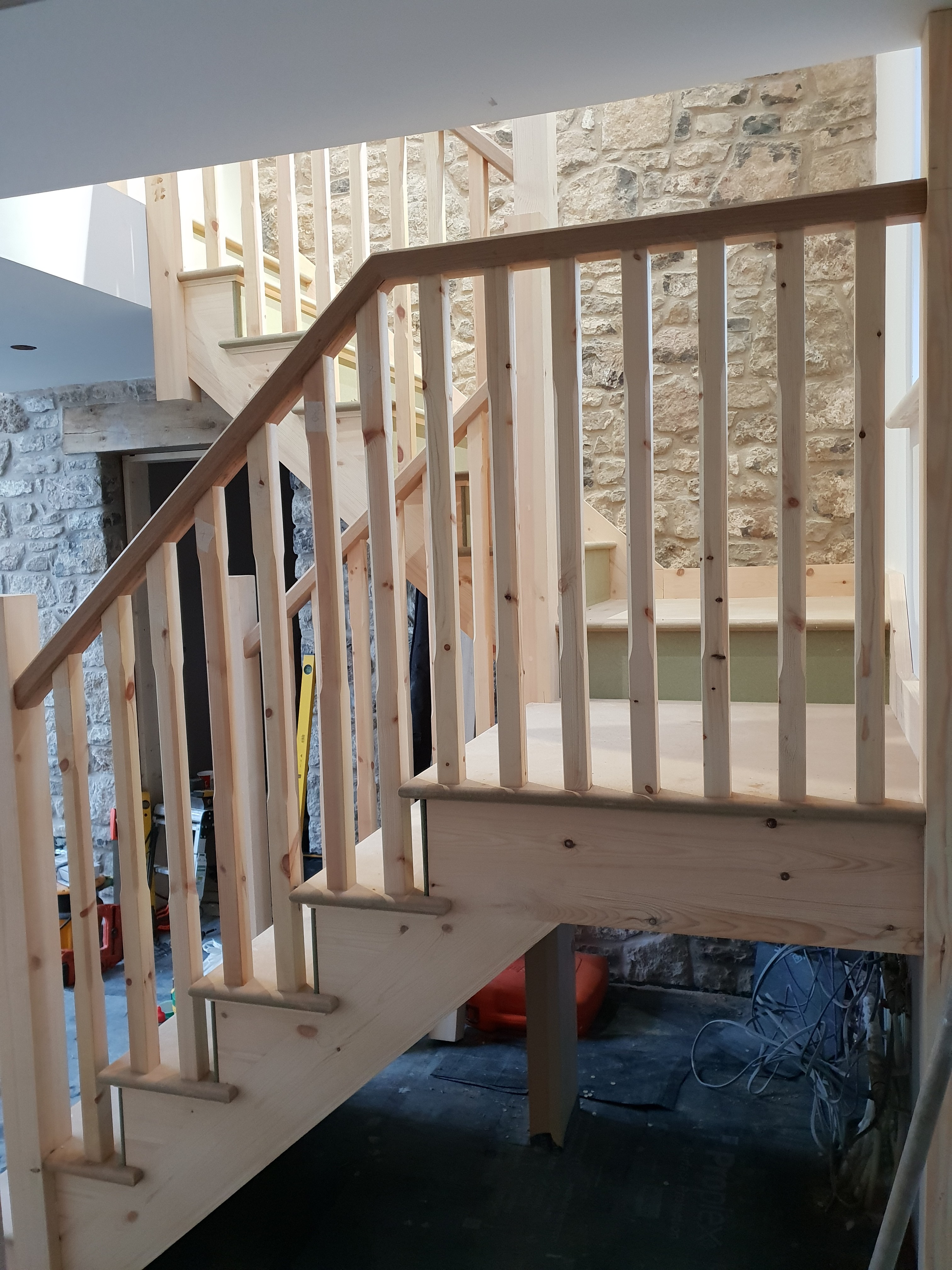 Modern bathroom featuring wooden cabinetry, a bathtub, a sleek sink, and natural light from a window.