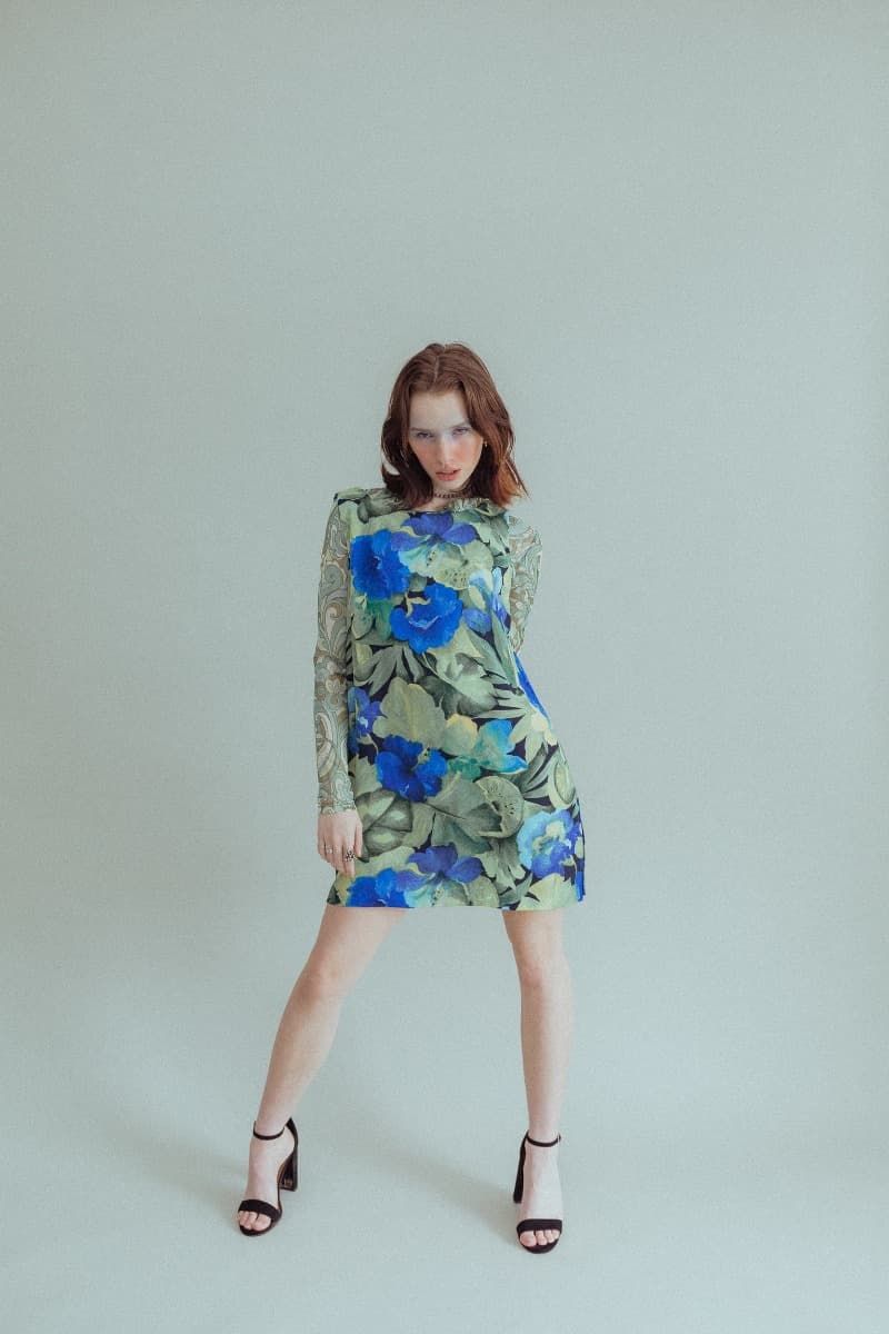 Model strikes a powerful pose in a blue floral dress at Revelator Studio in Shreveport, a top choice for natural light photography.