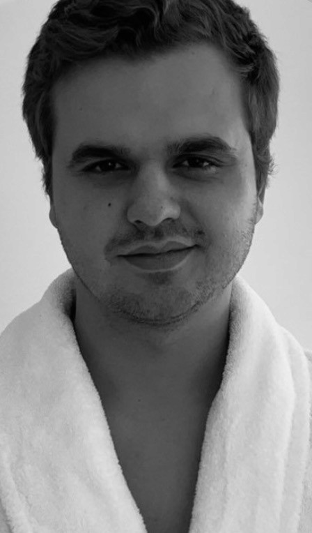 man sitting on gray concrete wall