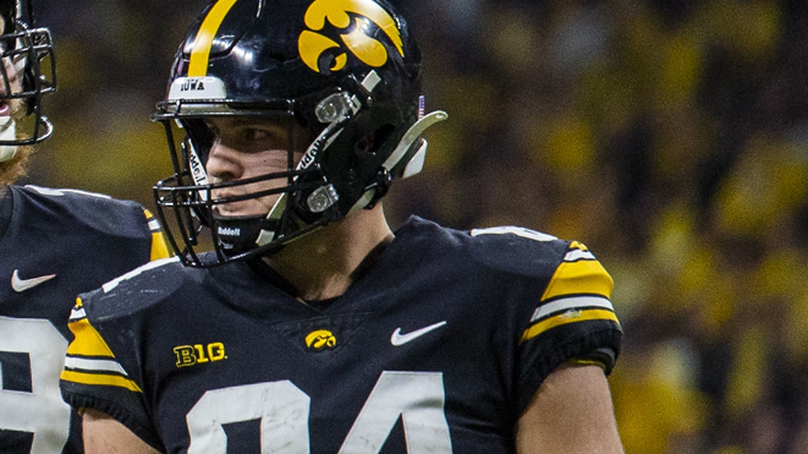 Close-up of Sam LaPorta in an Iowa Hawkeyes helmet, face clearly visible through the facemask