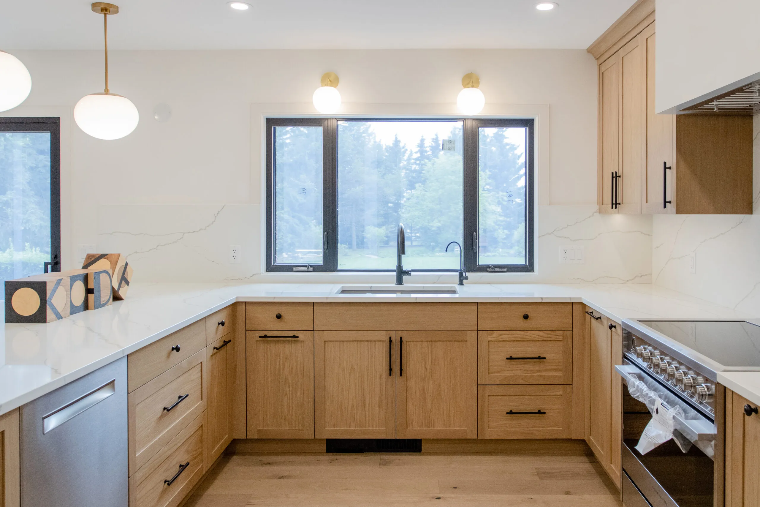 Image of warm kitchen with large window in front of sink.