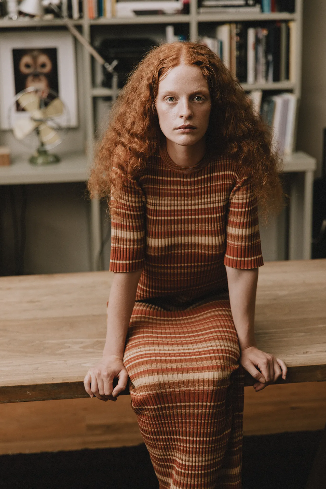 Annapurna SS26 collection rust and beige striped ribbed knit dress with elbow-length sleeves.