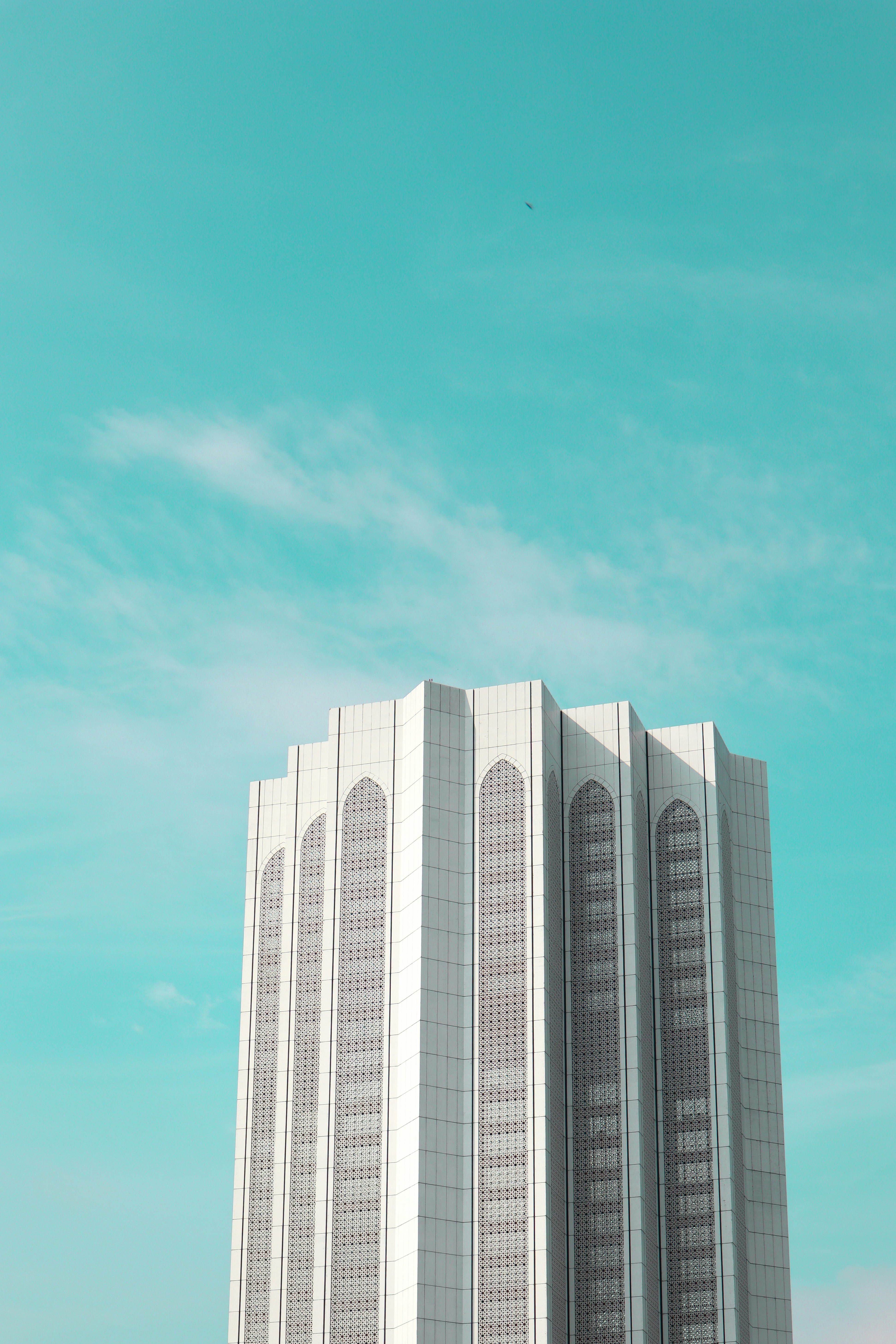 a tall white building with a sky background