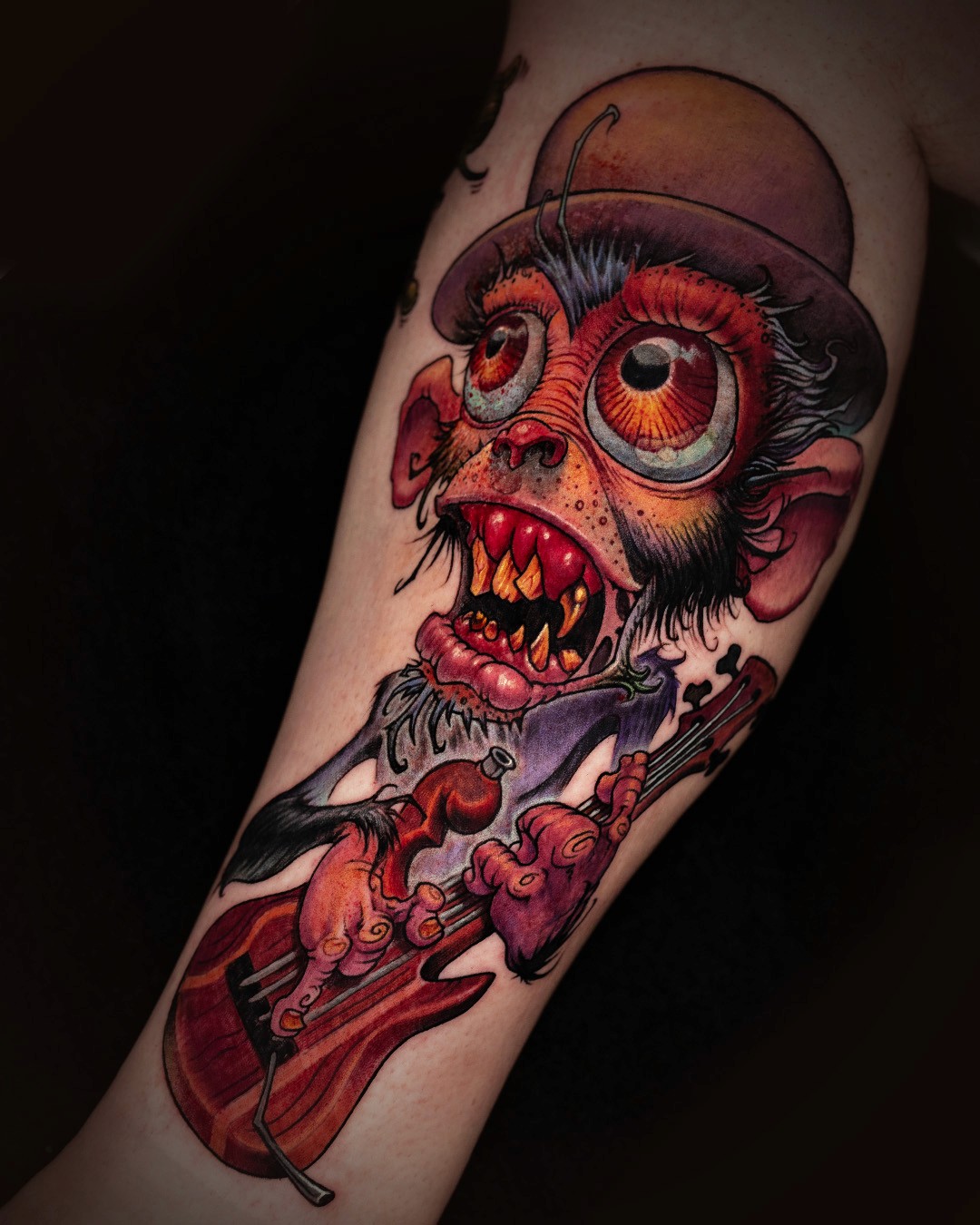 photo of new school tattoo of crazy monkey playing the guitar by tattoo artist Jesse Smith
