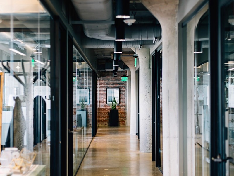 red train travelling near body of water