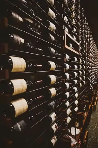 Cava with Wooden wine rack displaying multiple bottles of wine