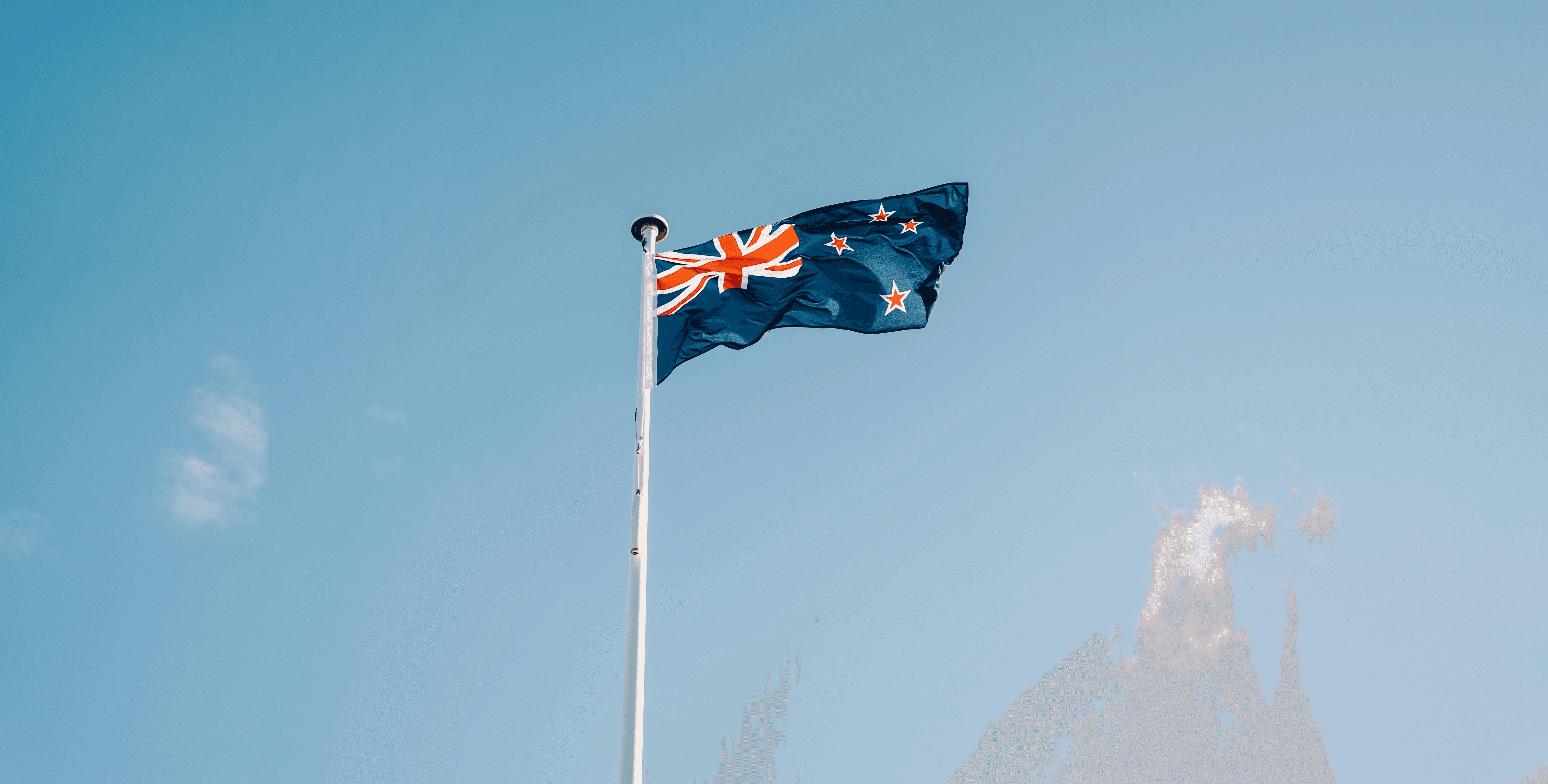 a flag flying in the wind on a clear day