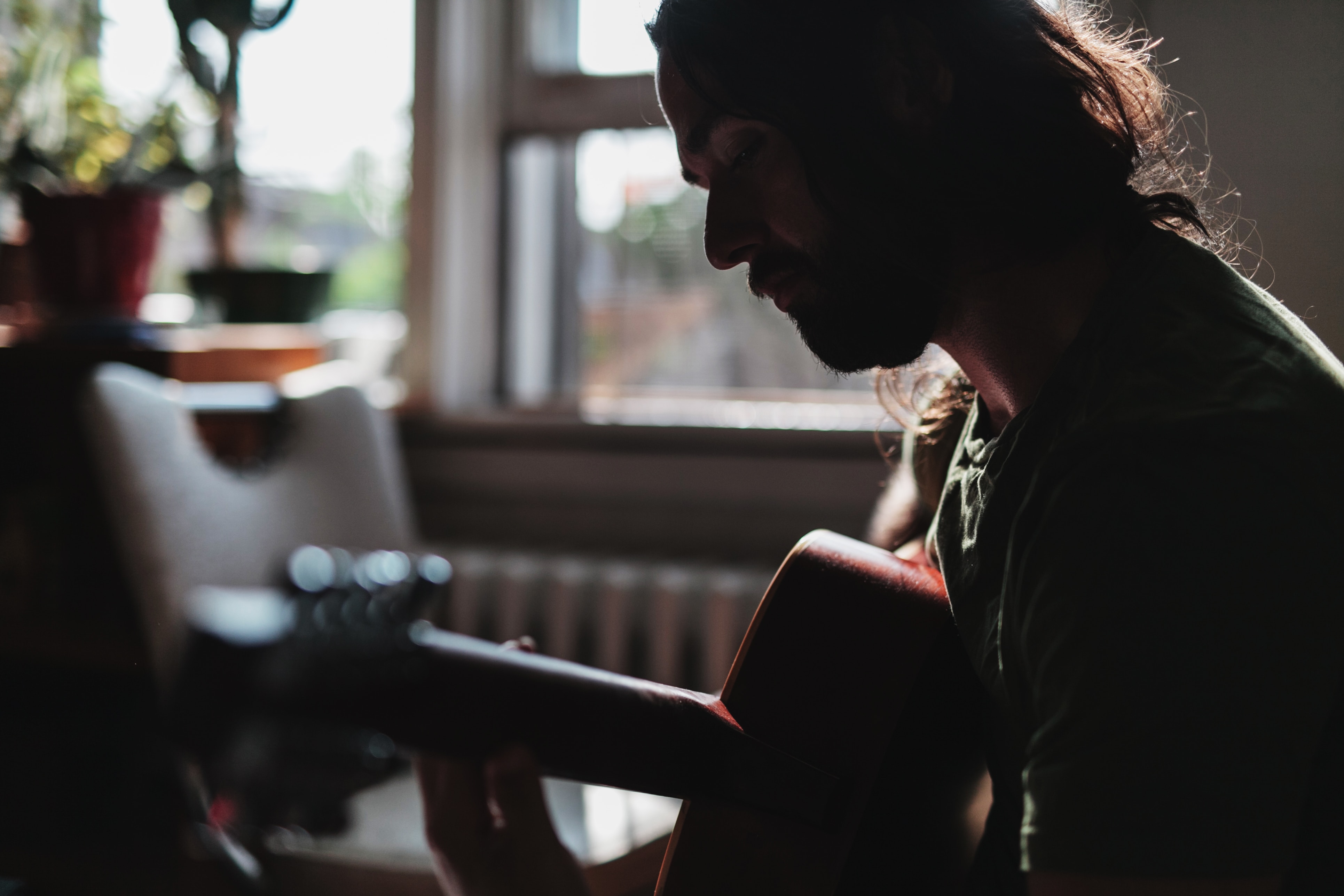 man playing guitar - how to make your own song 