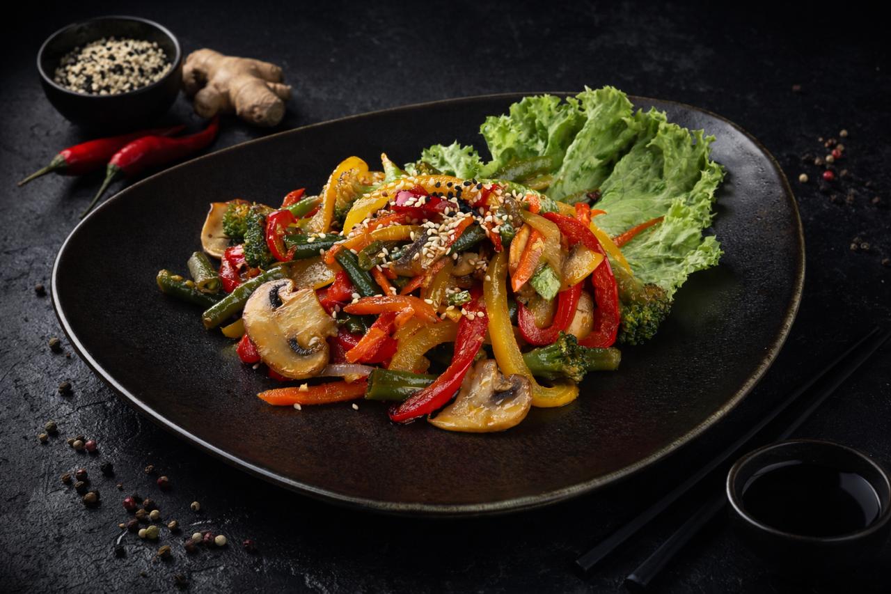 a white plate topped with meat covered in sauce