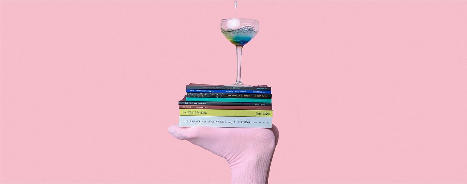 A drink placed on top of a stack of books
