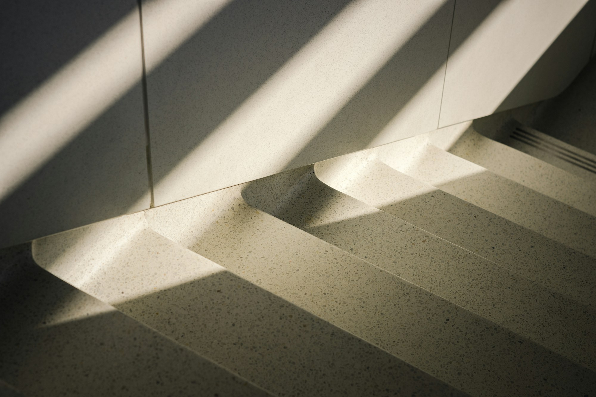Pale stairs striped with light and shadow