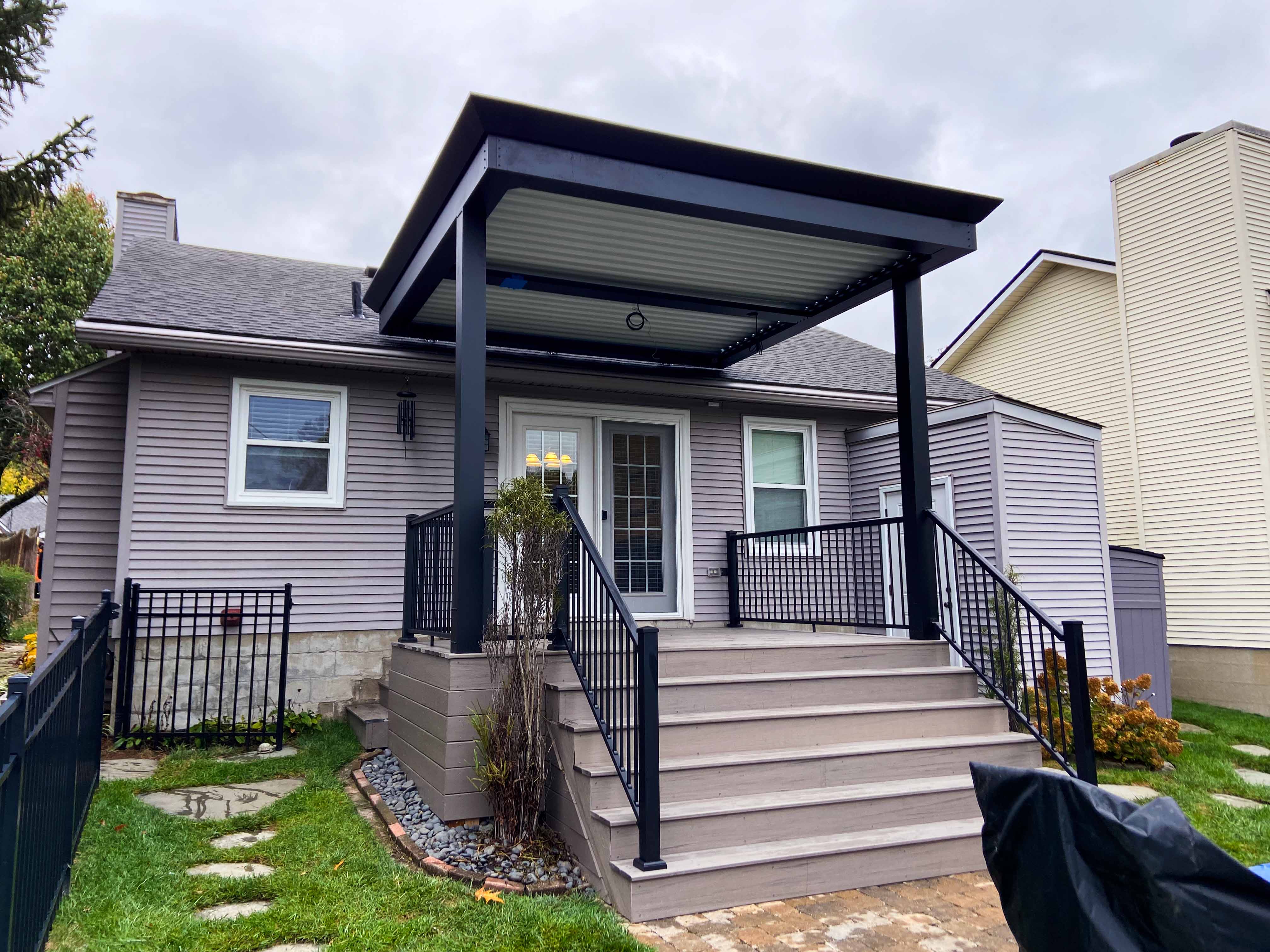 pergola added onto a home, needs lighting and fan installed