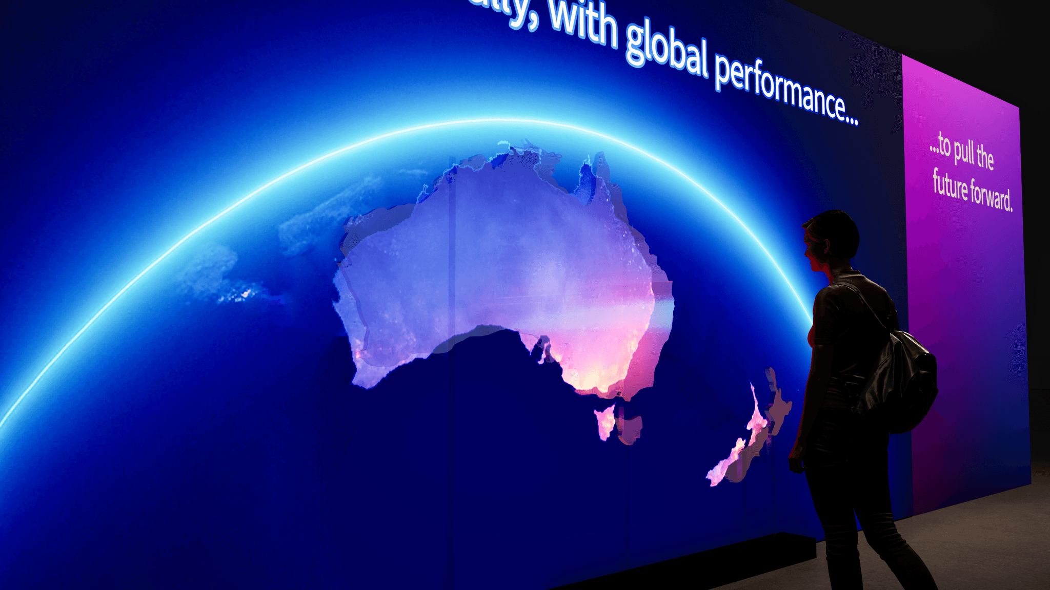 Large LED screen displaying global map for Amazon Web Services activation in dark exhibition space