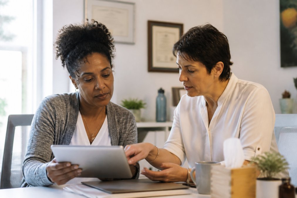 Healthcare practitioner reviewing lab results with a patient during a root cause approach to menopause consultation
