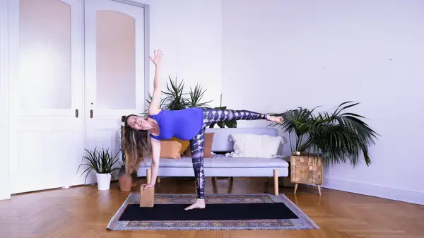 Pregnant woman in a modified side bend yoga pose – Day 6 prenatal yoga class to improve circulation and reduce swelling through twists and mindful breathing