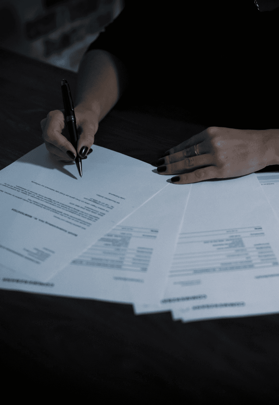 Woman signing on a paper.