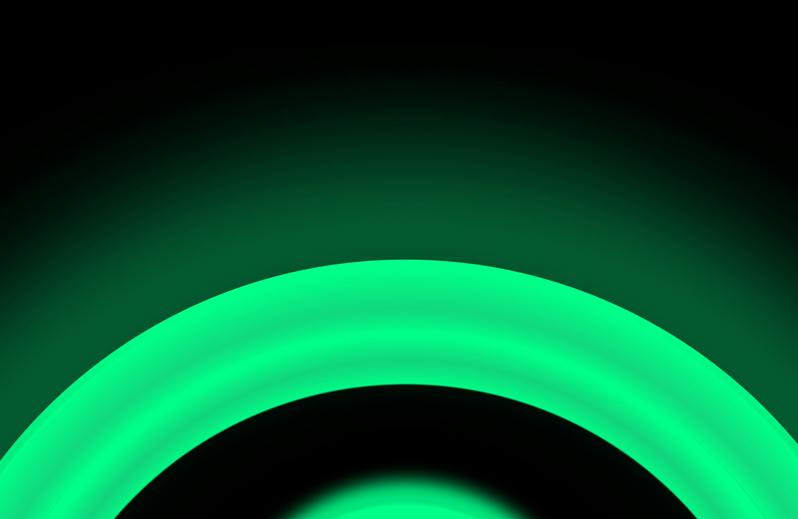 A glowing green circle on black background