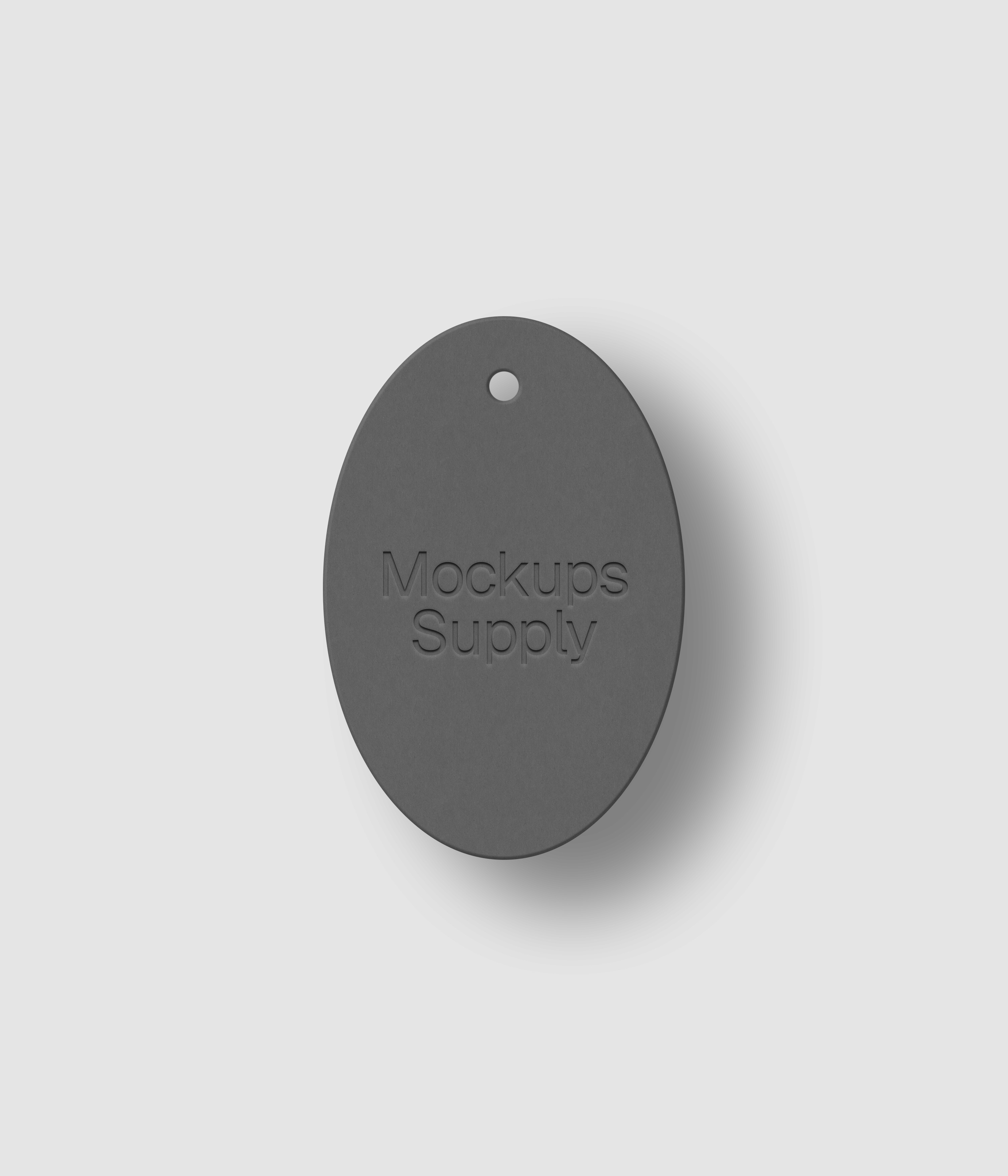 White vertical oval tag featuring letterpress pressed logo with drop shadow on customizable background for branding mockup