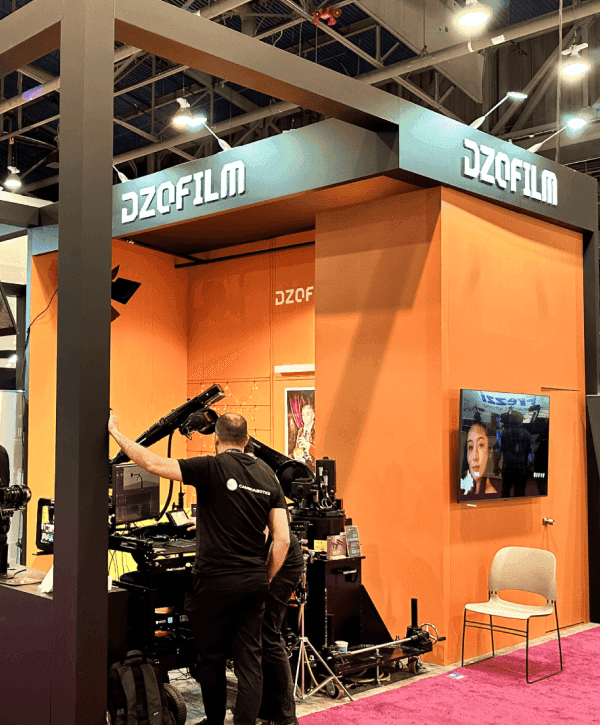 Large NAB Show booth overview with AV-focused presentation area, wide screen visibility, and open buyer-facing layout