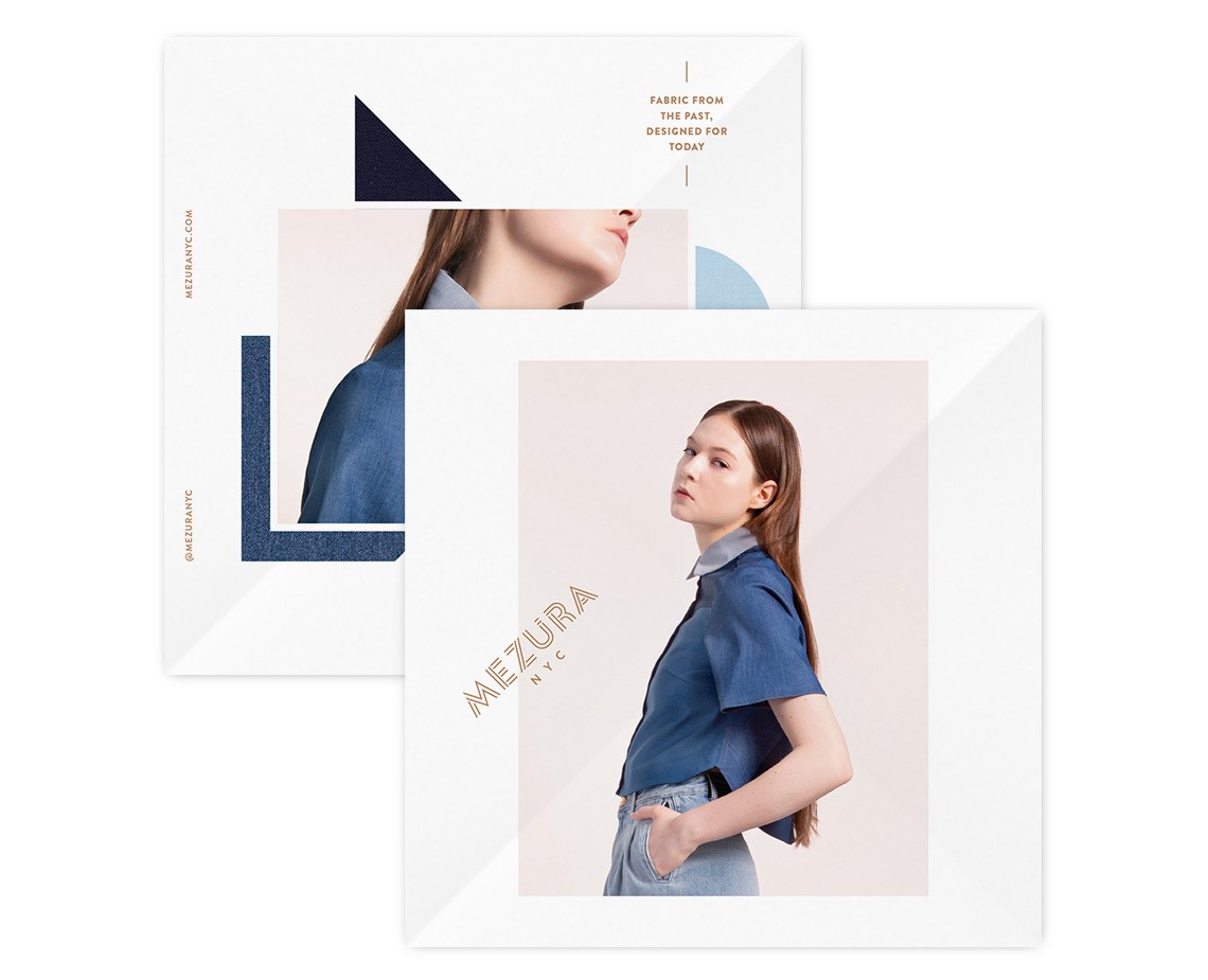 Two white cards are stacked, one partially overlapping the other. The top card displays a dark blue geometric shape and a partial view of a woman’s face. The bottom card features a light beige background with a woman in a blue denim shirt and light blue jeans, standing with one hand on her hip. The word “MEZURA NYC” is printed in gold on the bottom card.
