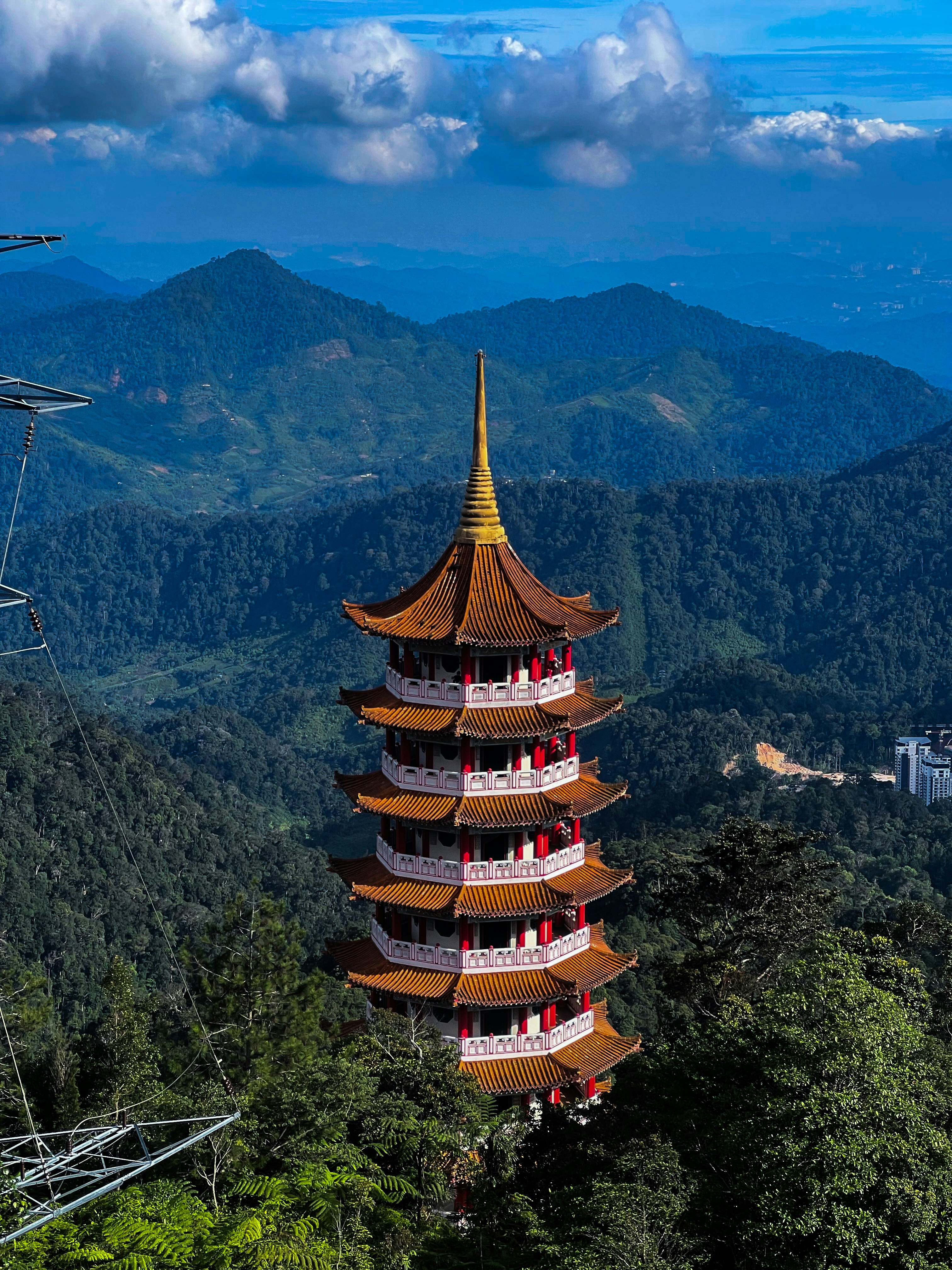 A beautiful temple overlooks lush mountains.