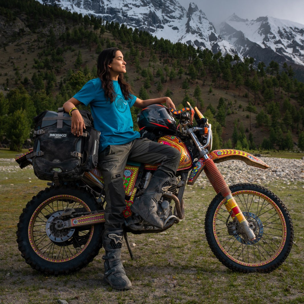 Alex Reynolds, co-owner of Coyote Den Hostel, with motorcycle in the mountains of Pakistan