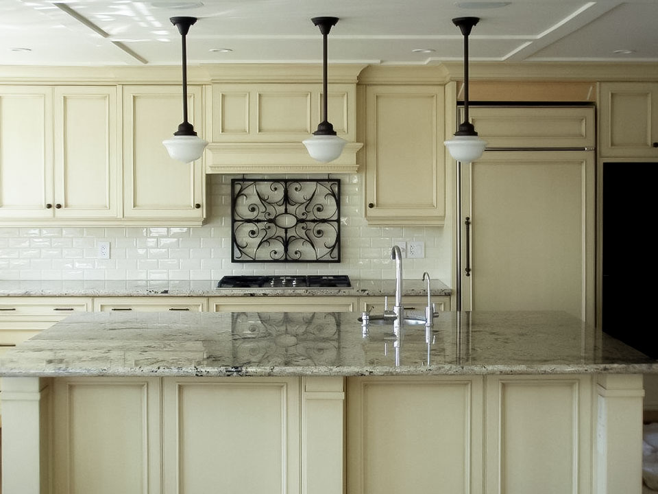 Image of Luxury kitchen design with white cabinetry, marble island, and stainless steel appliances by KHD Homes.