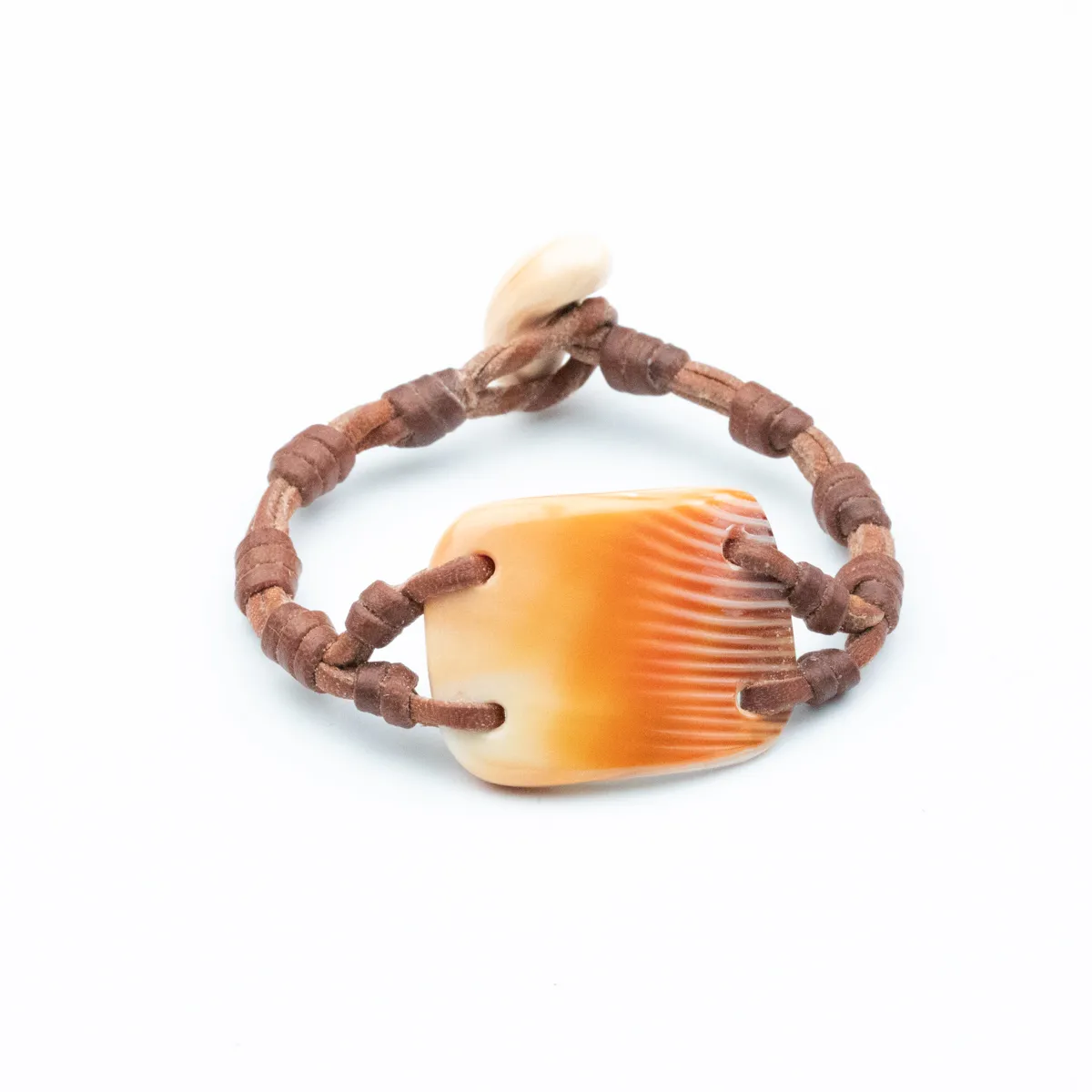 Seashell leather bracelet with ridged amber shell center and pale shell closure, hand-knotted brown leather cord — Manos de Oro Saint Barth