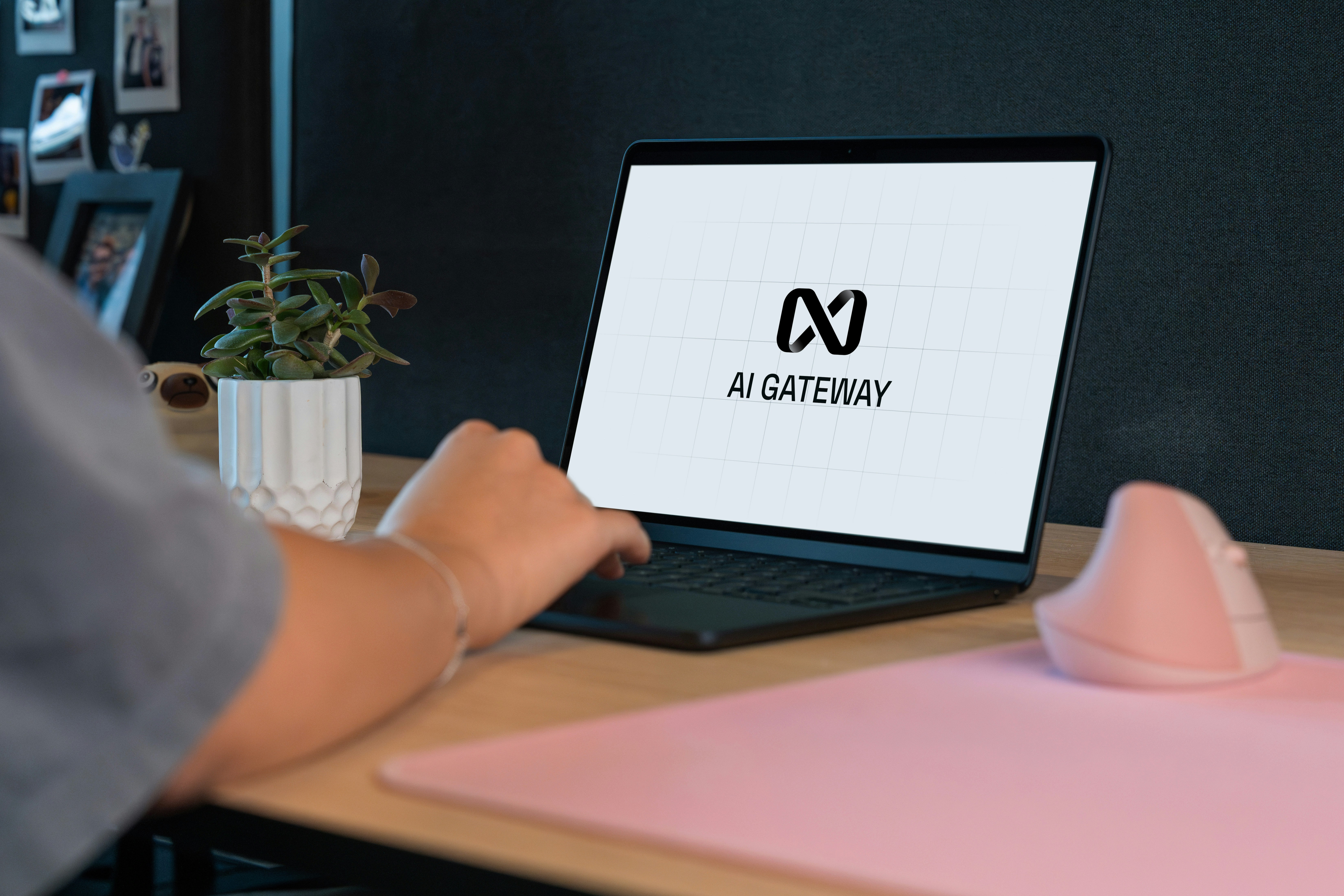 Person typing on laptop with "ai gateway" logo.