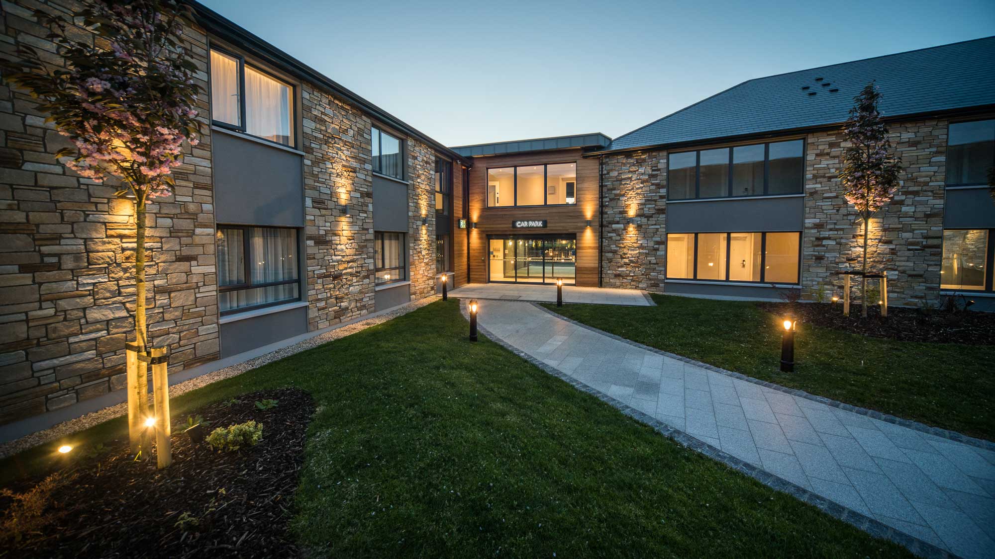 View of Hotel Kilmore’s modern extension: exterior showing new bedrooms with clean lines, large windows, and landscaped paths.