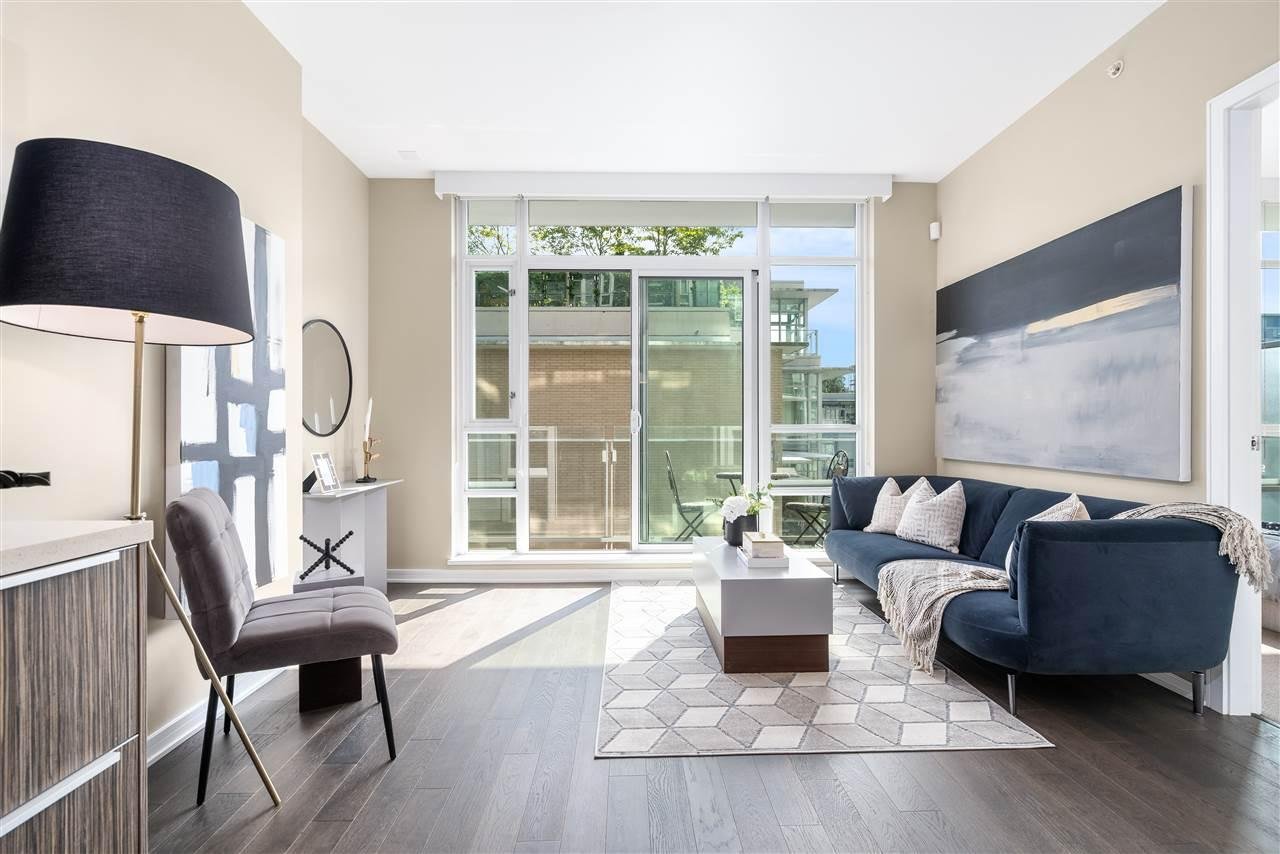 Bright and modern living room with large windows, sleek furniture, and a cozy ambiance.