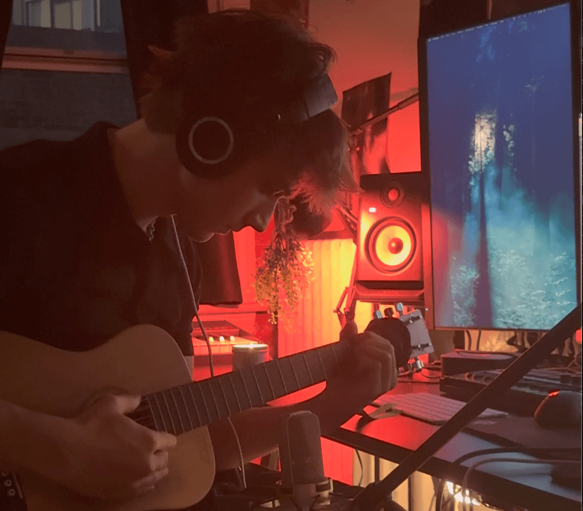 A close-up of a pink cocktail in a martini glass, set against a nighttime background with soft, blurred colors.