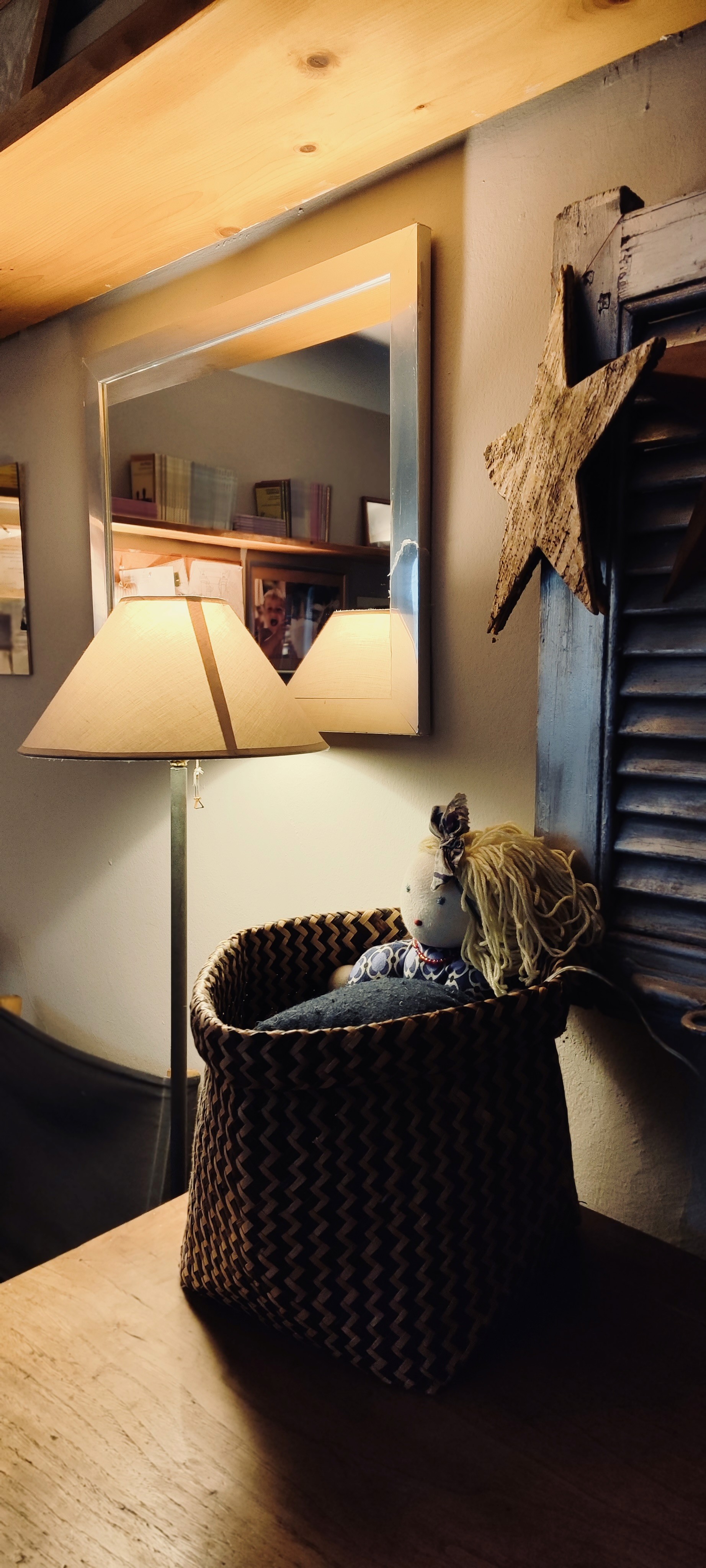 woman in white sweater holding black round frame
