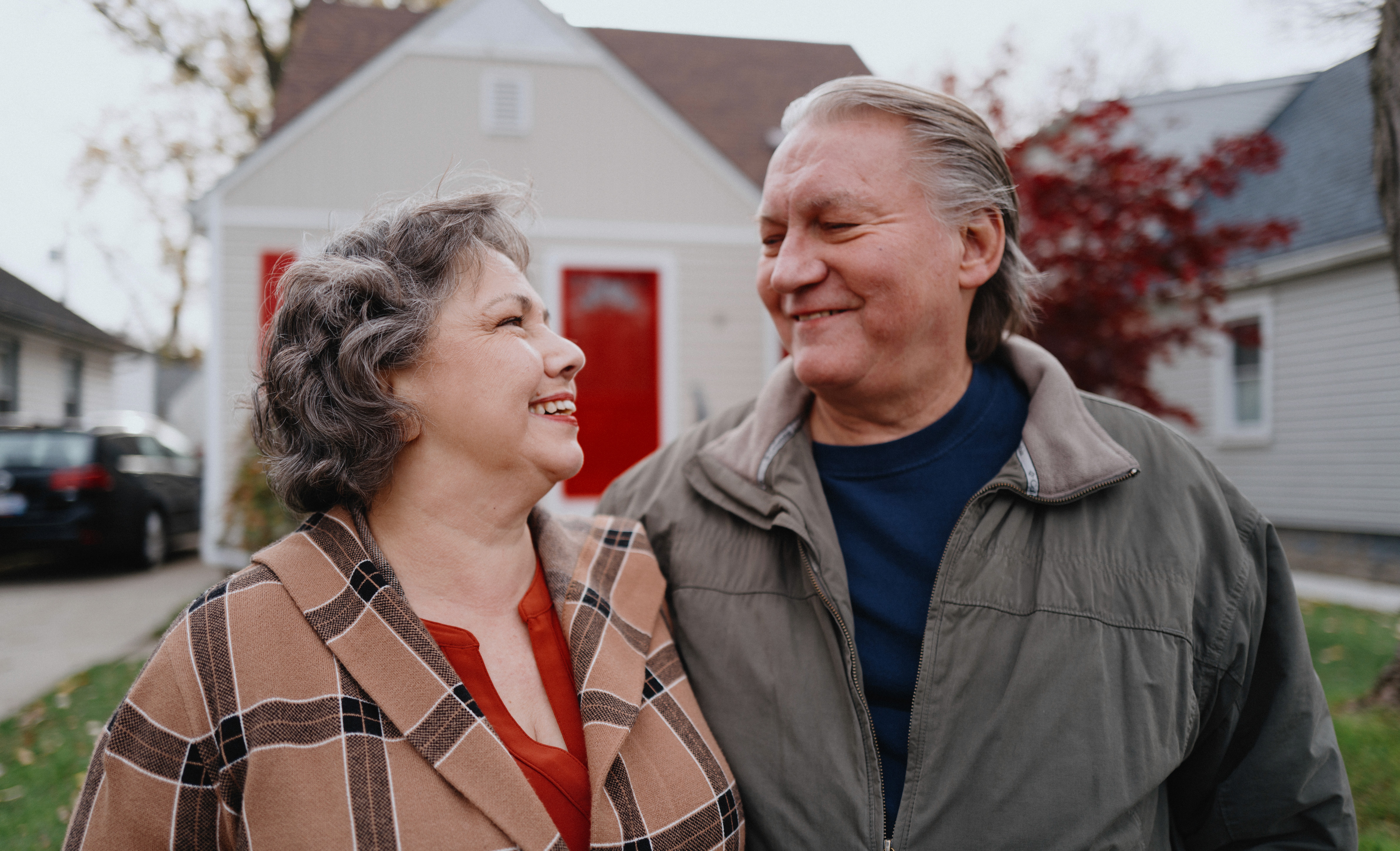 Older couple smiling at one another