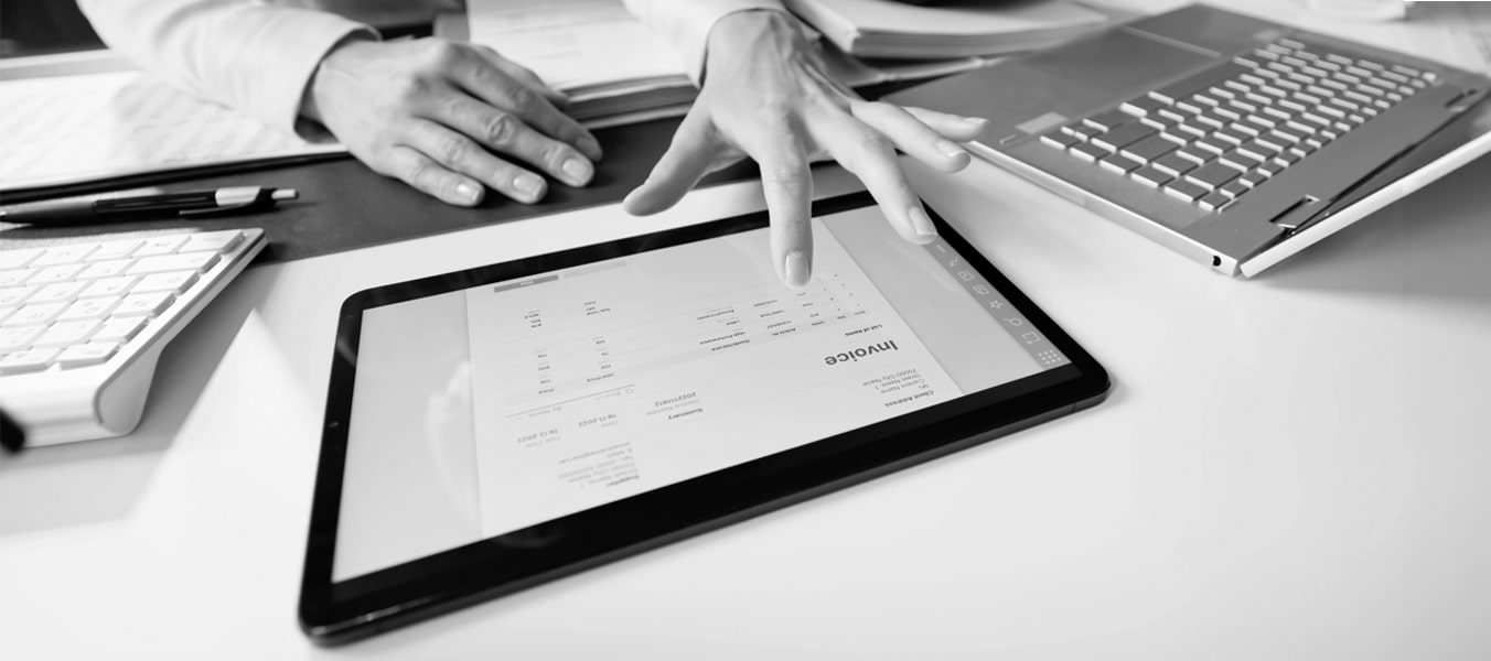 Business owner checking an invoice on his tablet